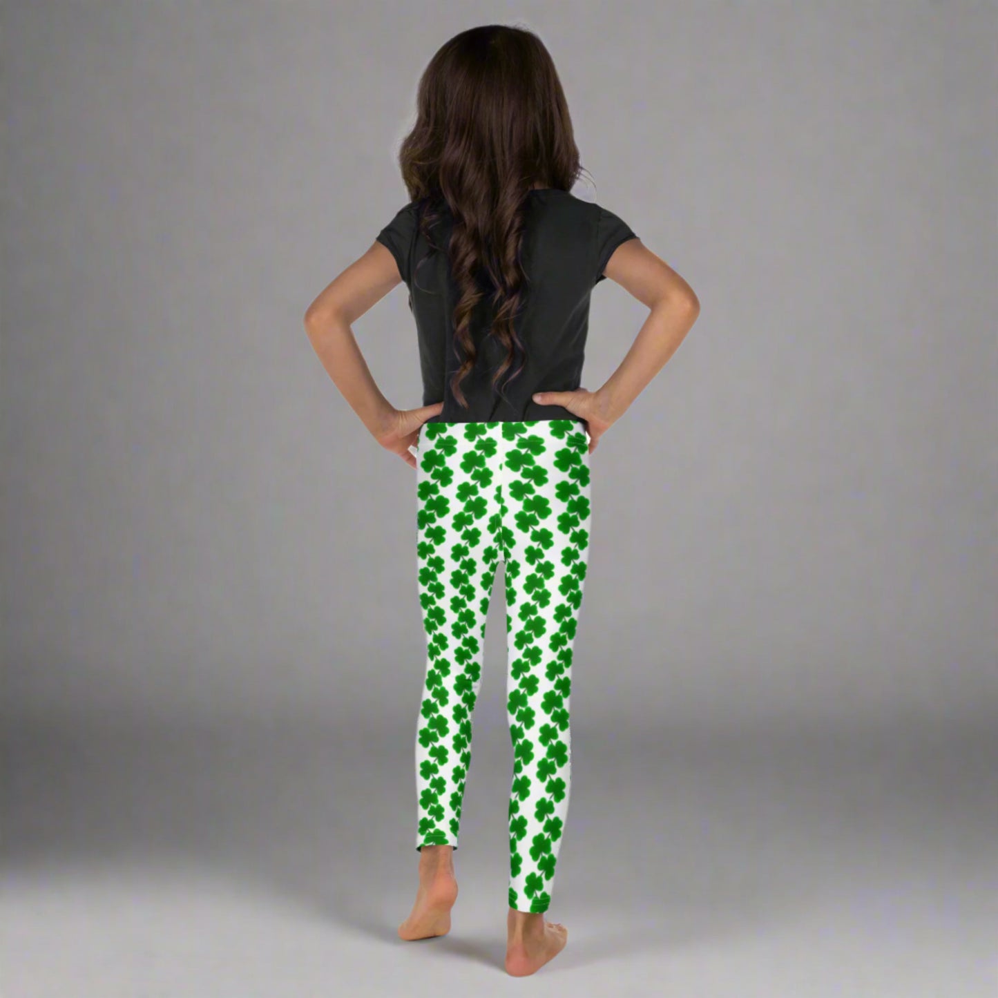 Image: St Patricks Day Leggings for toddlers and girls. Great white tights with a pattern of four leaf covers repeating down each leg. Also available in tween girl and womens sizes for family matching outfits, by jaecrece