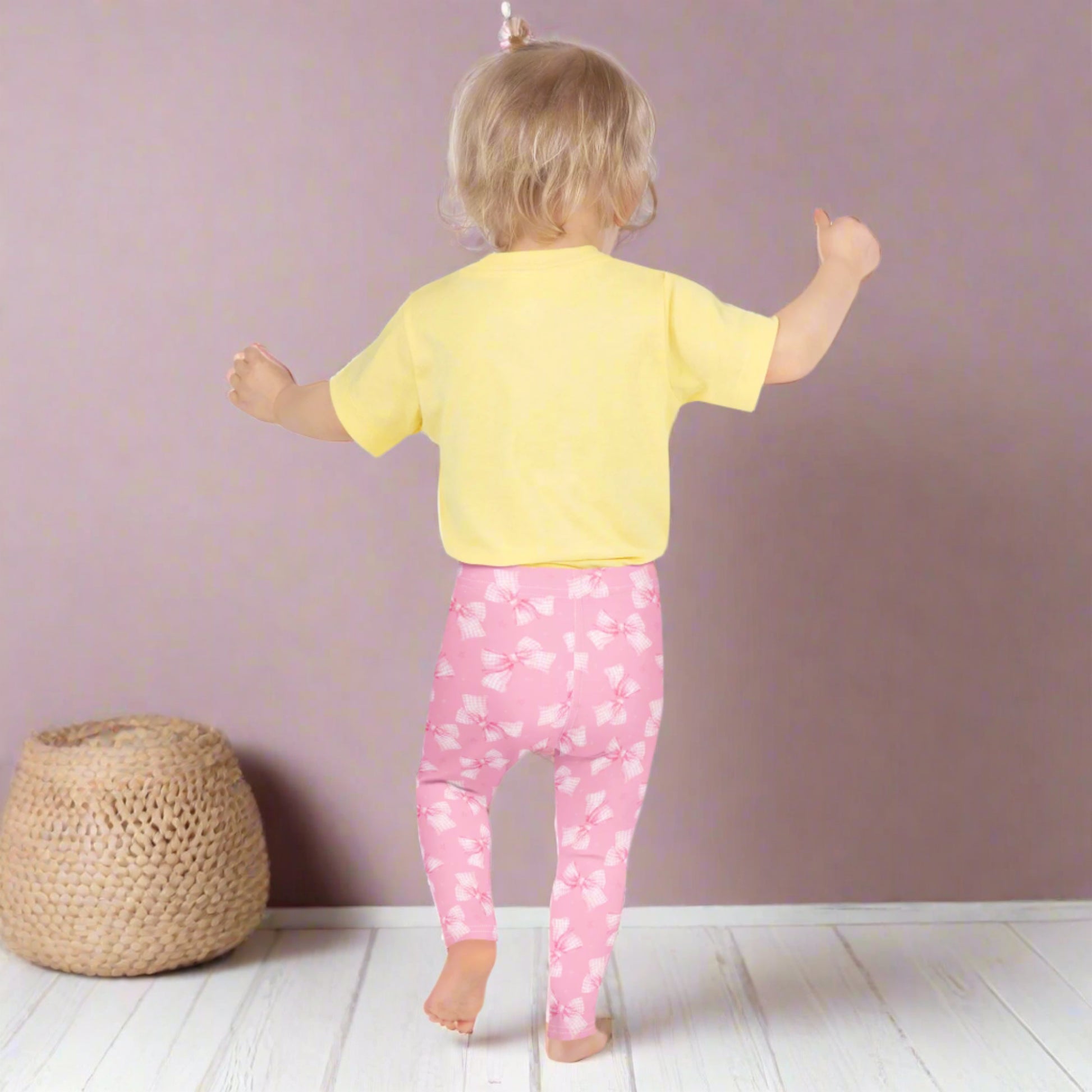 Image: These pretty pink bow leggings for toddler and girl sizes 2T through 7 are a fun and fashionable way to dress your little one. The gingham ribbon print and soft stretch fabric are perfect for everyday adventures or dressing up for holidays and birthdays. A must-have for girly girls who love to match, by jaecrece.
