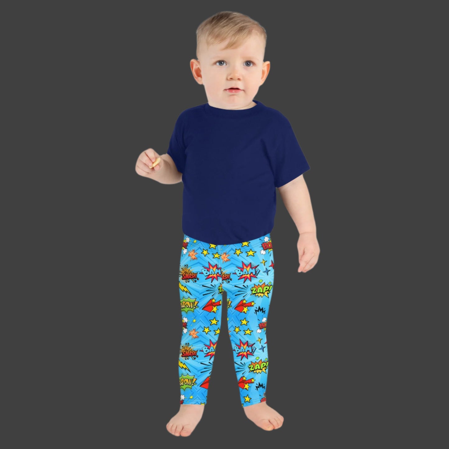 Blue leggings in size 2T-7, with superhero graphics, and phrases like: Bam, Smash, Zap, Kapow. Comic Book Toddler Leggings, Superhero Kids Pants, Comic Con Cosplay Tights, Birthday Party Gift for Boys or Girls, by jaecrece