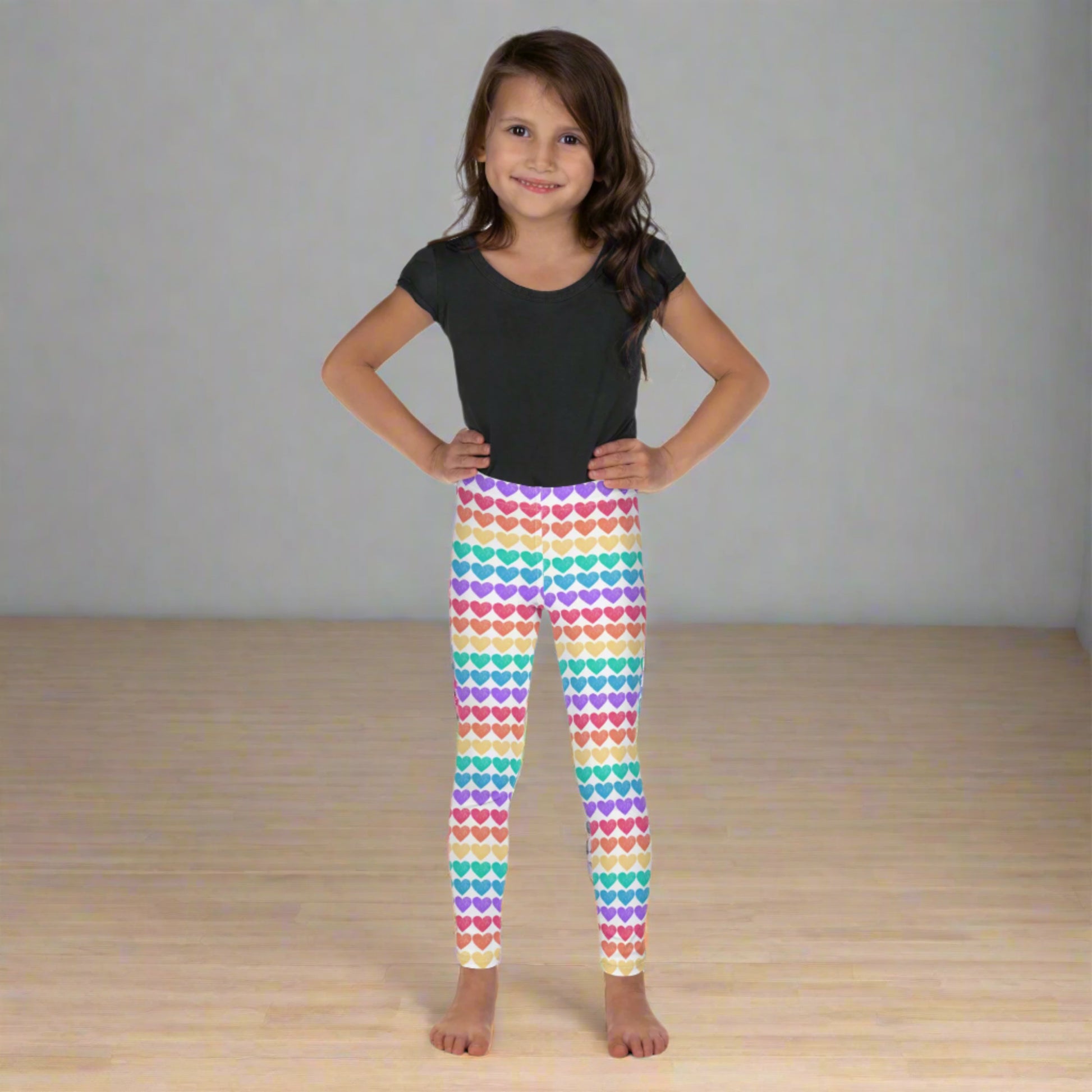 Bring color and comfort to your toddler's wardrobe with these rainbow heart leggings. Sizes 2T–7 fit growing girls perfectly with a stretchy, soft fit. Ideal for matching outfits with older siblings or mom, these leggings are perfect for Pride, preschool, or park days. The durable microfiber fabric makes them a go-to for style and movement.