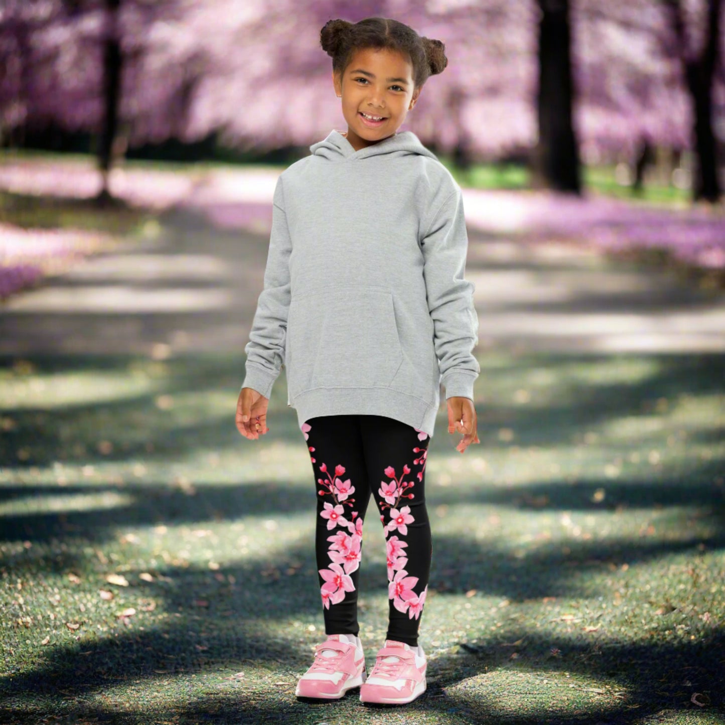 Image: Japanese Cherry Blossom Girls and Toddler Leggings, in sizes 2T, 3t, 4T, 5T, 6, 6X and 7. Black leggings with a swirl of Japanese cherry blossoms going down the outside of each leg. Elastic, soft, and durable with vibrant colors. Part of a matching collection for younger children and women, each pair is precision-cut and hand-sewn for a perfect fit.