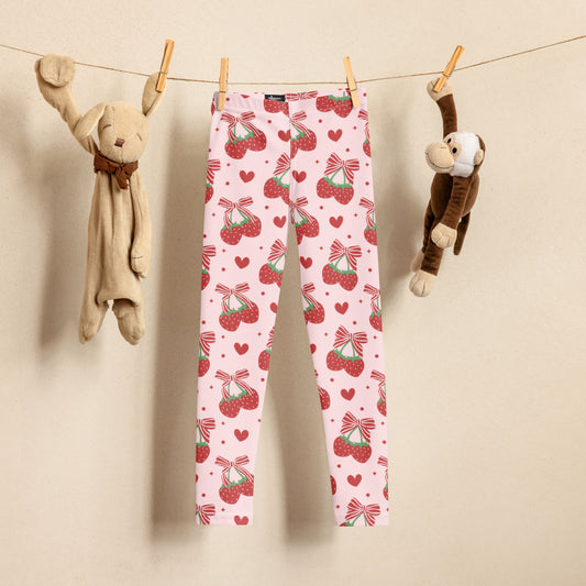 Image: These adorable pink leggings for toddlers and little girls feature a playful print of red striped bows and bright strawberries. Designed in sizes 2T to 7, they’re perfect for tea parties, dance class, or twirling through the day. Whether worn with a tutu or a comfy top, these sweet leggings add fun and charm to any outfit and make a delightful gift for your favorite little fashionista, by jaecrece.