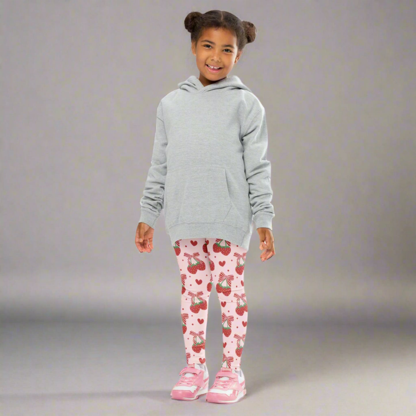 Image: These pink strawberry leggings for toddlers and girls sizes 2T to 7 combine playful style with comfort. Featuring red ribbon bows and fruity accents, they’re made for busy days full of fun and imagination. Whether she’s heading to daycare, the park, or a family event, these leggings are a cute and colorful choice for your little fashion star, by jaecrece.