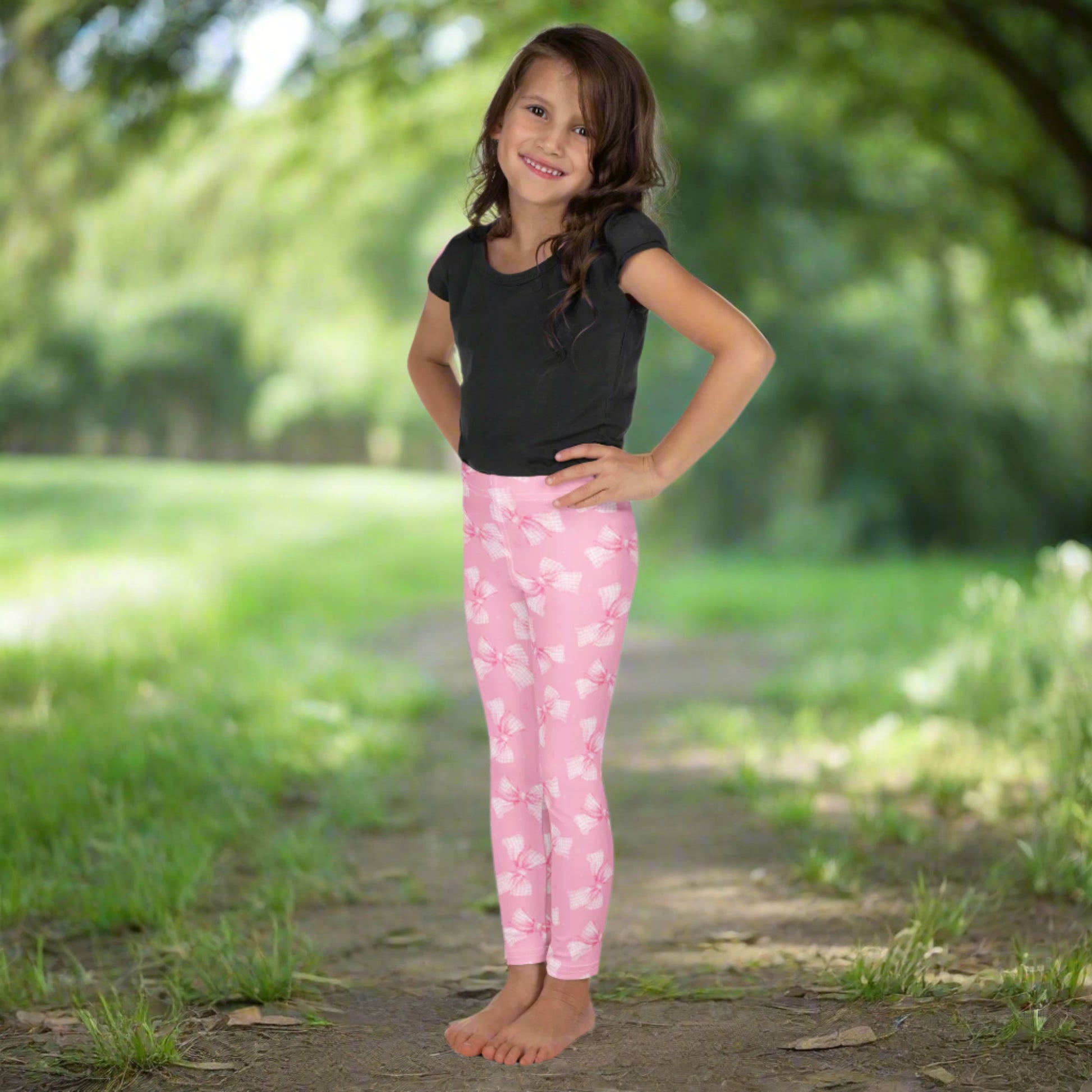 Image: Add charm to your little one’s wardrobe with these pink coquette leggings for toddler and girl sizes 2T through 7. Covered in cute gingham bows, they are soft and stretchy for all-day play. Whether worn to a party, daycare, or playdate, these leggings bring stylish fun to every moment. Perfect for little fashion lovers, by jaecrece.