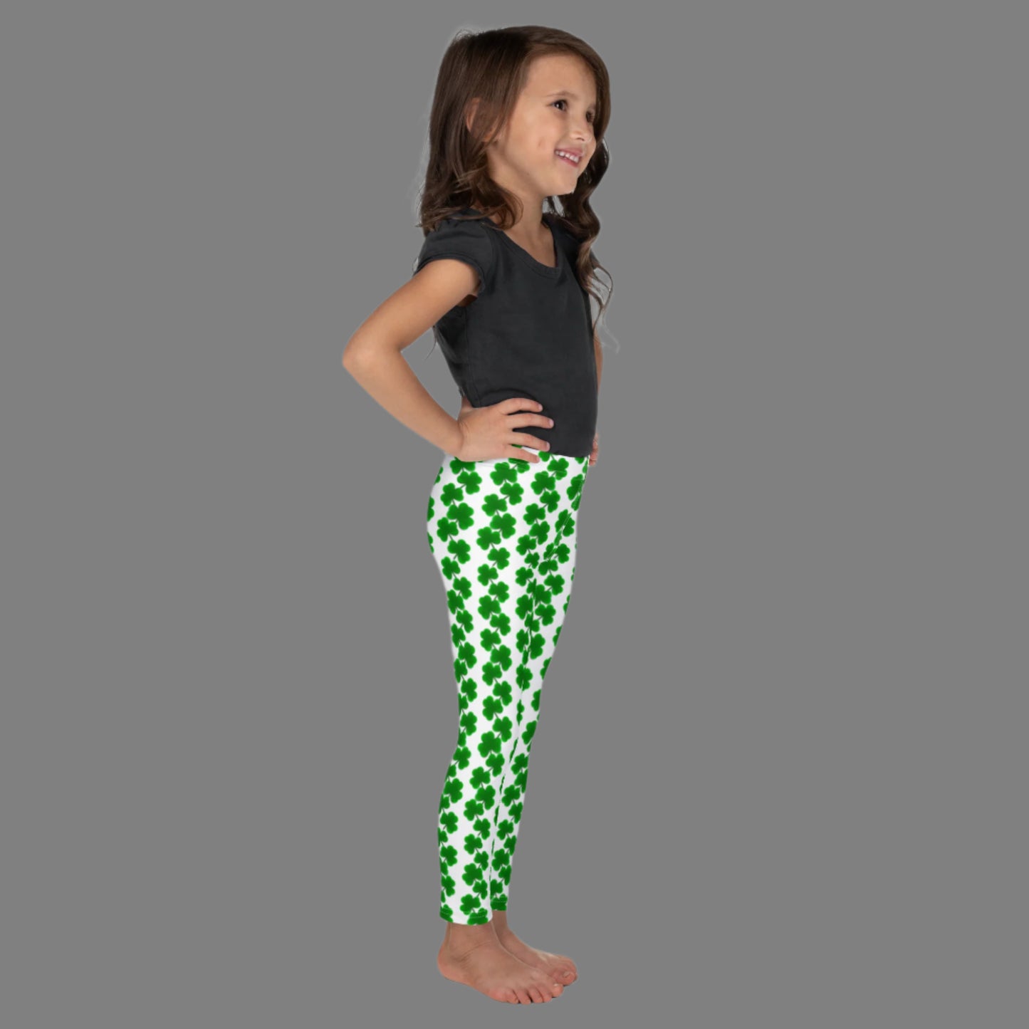 Image: St Patricks Day Leggings for toddlers and girls. Great white tights with a pattern of four leaf covers repeating down each leg. Also available in tween girl and womens sizes for family matching outfits, by jaecrece