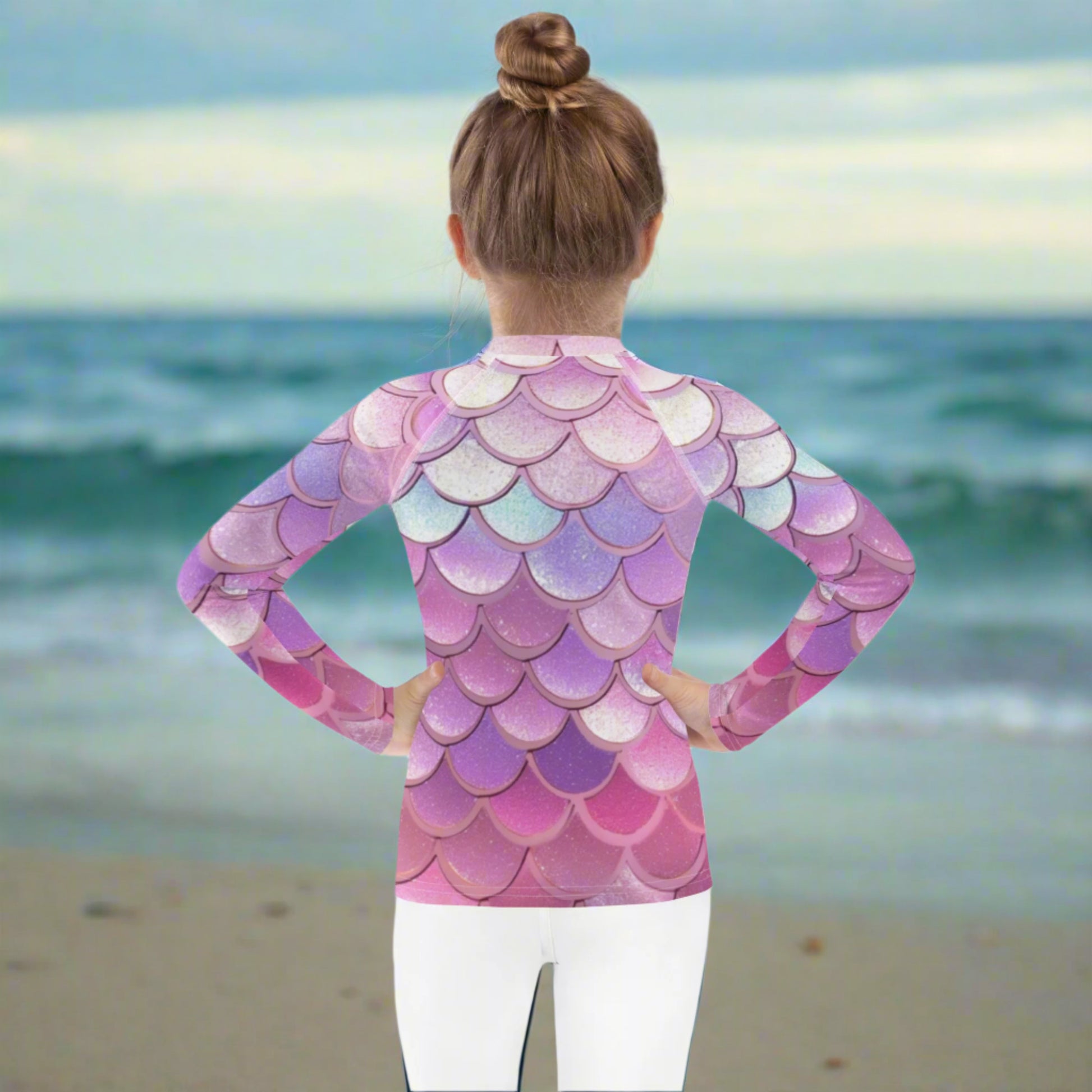 Image: Pink Mermaid Scales Girls rash guard. This swimwear is in toddler and girl sizes, and is part of a family matching swimwear collection. It features mermaid scales in shades of pink, blue and purple, by jaecrece