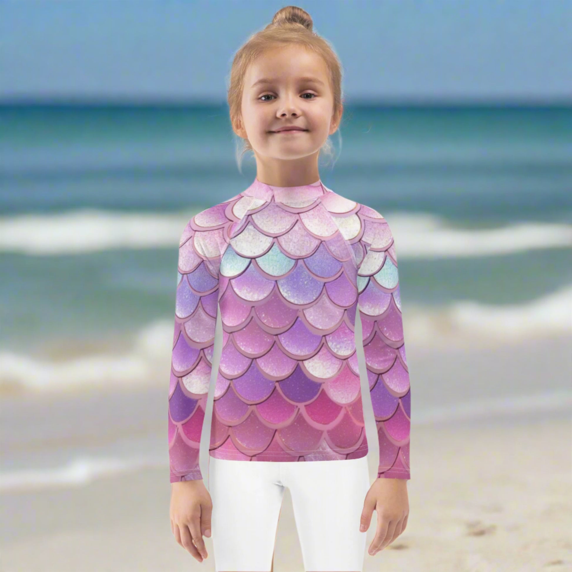 Image: Pink Mermaid Scales Girls rash guard. This swimwear is in toddler and girl sizes, and is part of a family matching swimwear collection. It features mermaid scales in shades of pink, blue and purple, by jaecrece