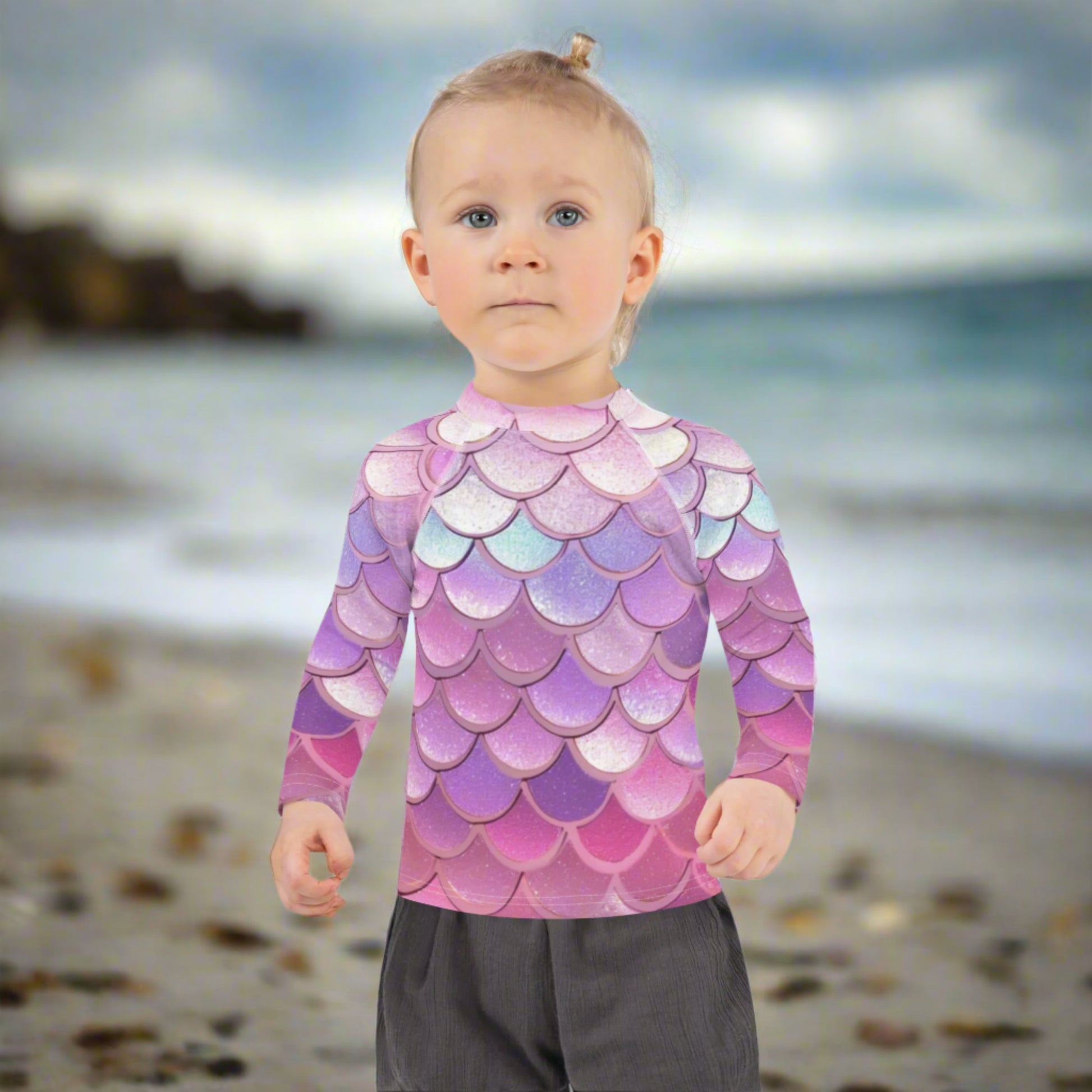 Image: Pink Mermaid Scales Girls rash guard. This swimwear is in toddler and girl sizes, and is part of a family matching swimwear collection. It features mermaid scales in shades of pink, blue and purple, by jaecrece