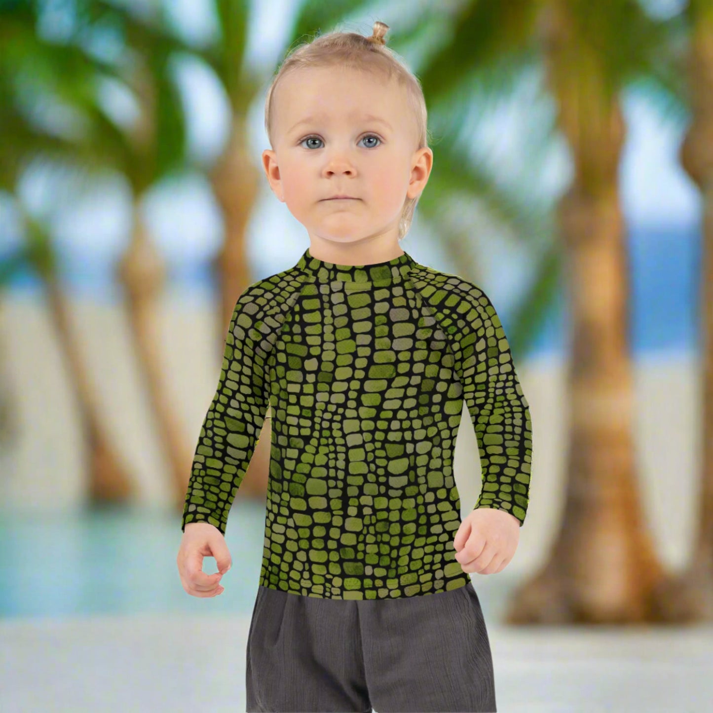 Green reptile scale rash guard for boys and girls in toddler sizes 2T–7. Long sleeve swim top with costume potential for dinosaurs, snakes, and jungle reptiles. Soft, flexible fabric provides UV protection while supporting active play. Great for water parks, lakeside fun, or themed vacations. Bold and colorful for little nature explorers.