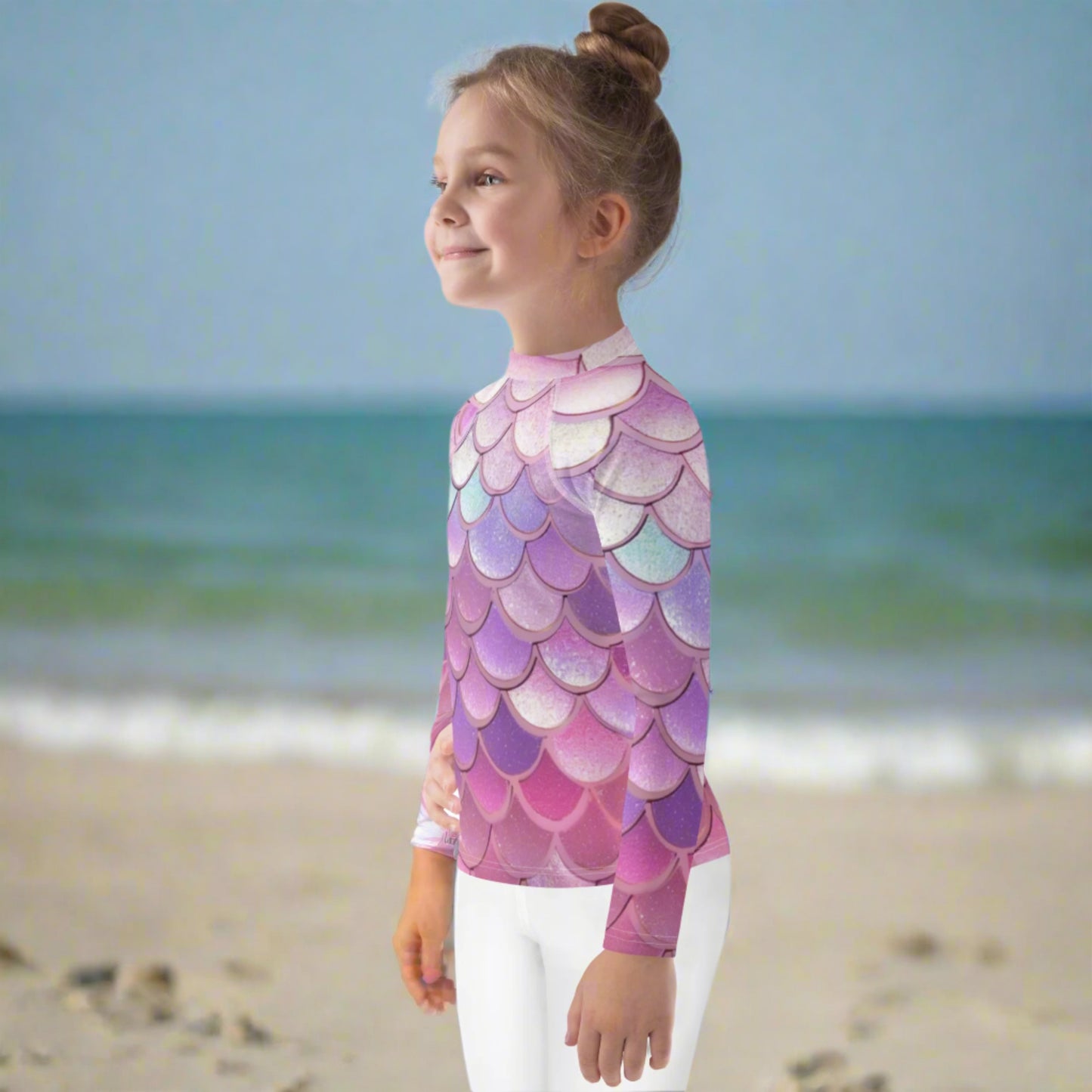 Image: Pink Mermaid Scales Girls rash guard. This swimwear is in toddler and girl sizes, and is part of a family matching swimwear collection. It features mermaid scales in shades of pink, blue and purple, by jaecrece