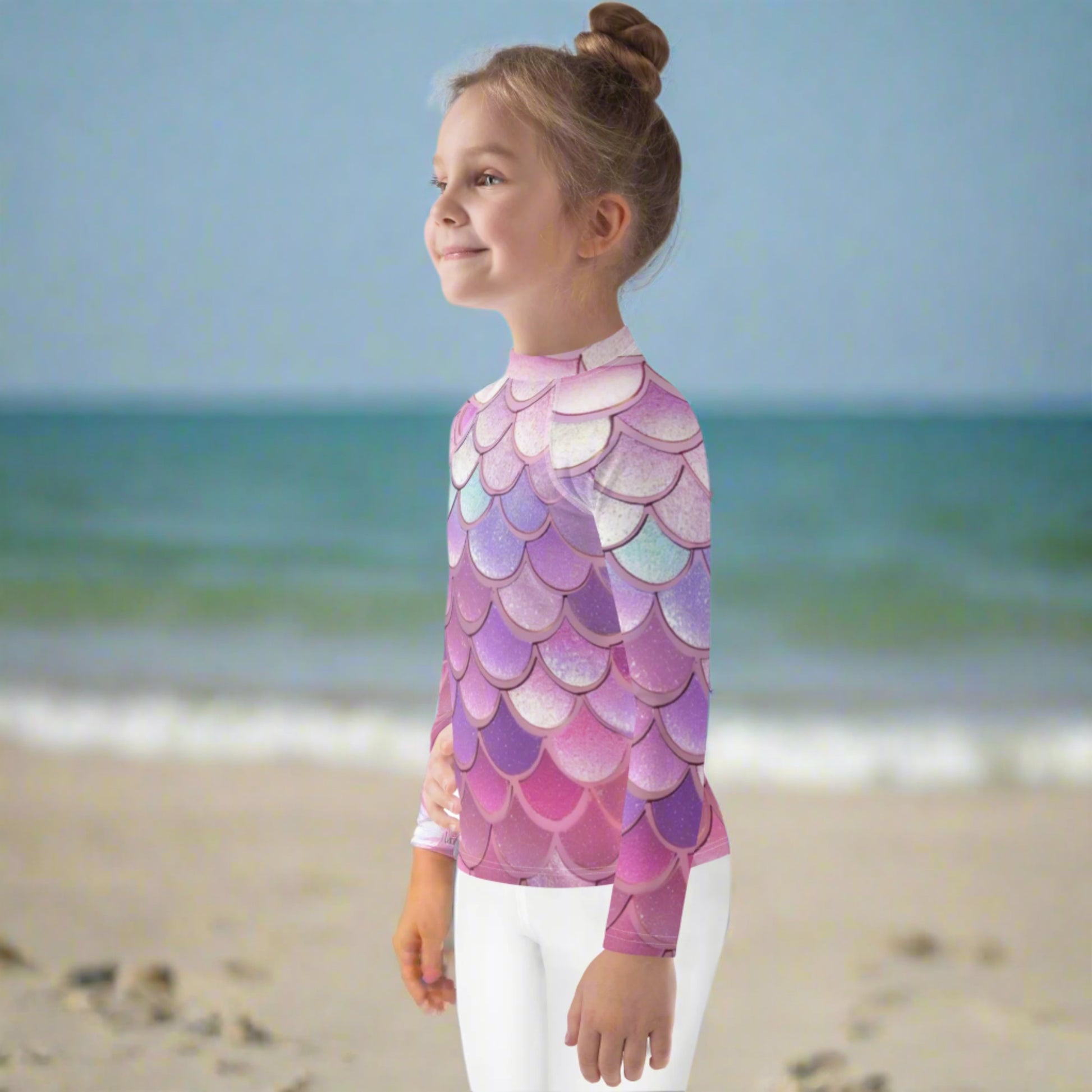 Image: Pink Mermaid Scales Girls rash guard. This swimwear is in toddler and girl sizes, and is part of a family matching swimwear collection. It features mermaid scales in shades of pink, blue and purple, by jaecrece