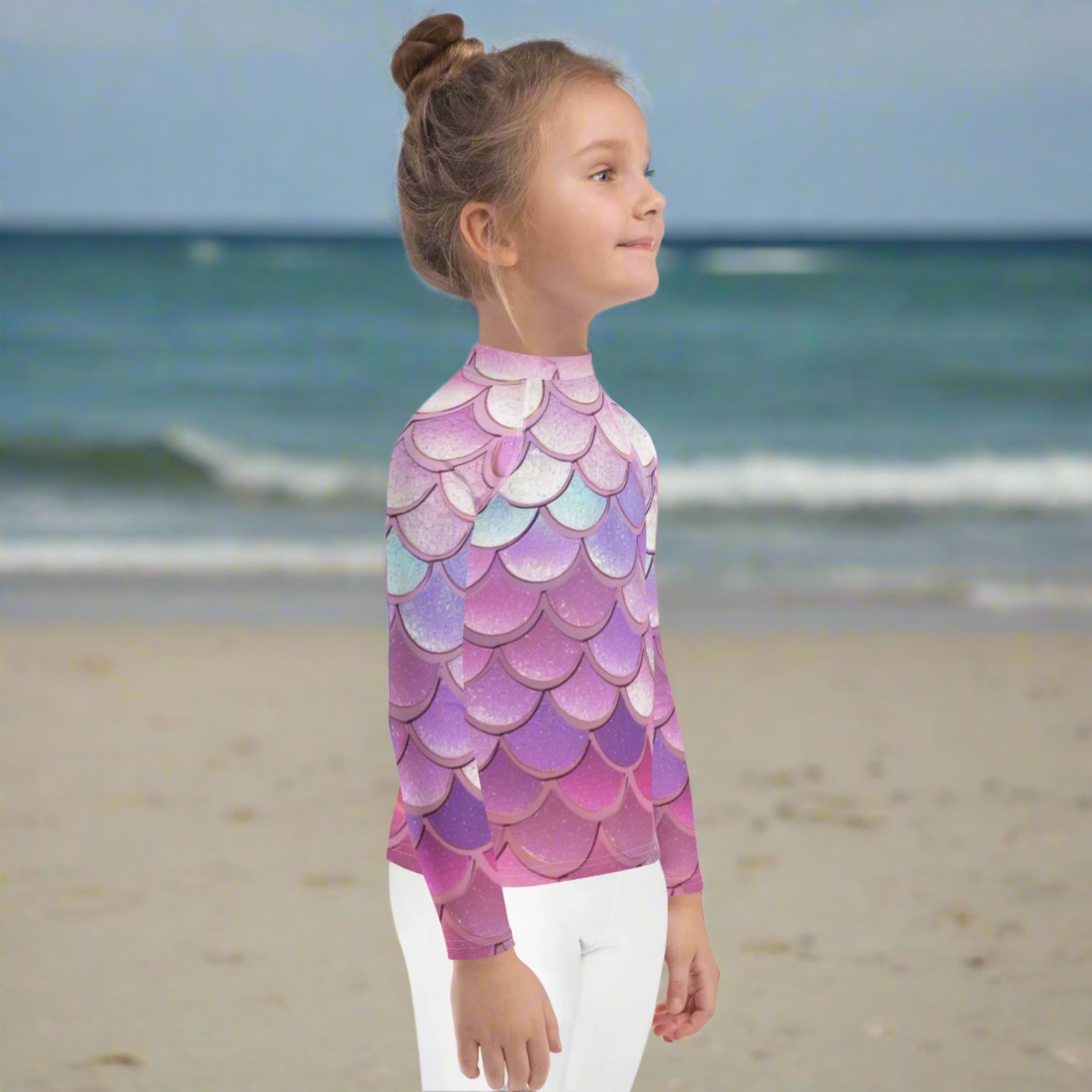 Image: Pink Mermaid Scales Girls rash guard. This swimwear is in toddler and girl sizes, and is part of a family matching swimwear collection. It features mermaid scales in shades of pink, blue and purple, by jaecrece