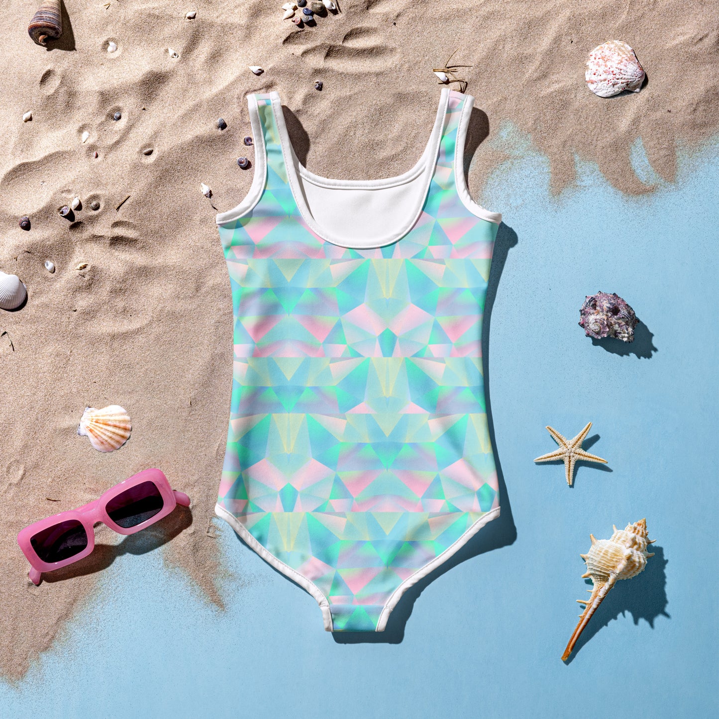 Girls toddler pastel swimsuit in sizes 2T–7, designed with bright rainbow colors, a secure double-layered front, and UPF 38–40 fabric for safe summer fun. Comfortable microfiber yarn and four-way stretch allow for active play at the pool or beach. This swimsuit is part of a family matching swimwear collection that includes sizes for girls 8–20, women’s swimsuits, men’s trunks, and a coordinating pastel beach towel.