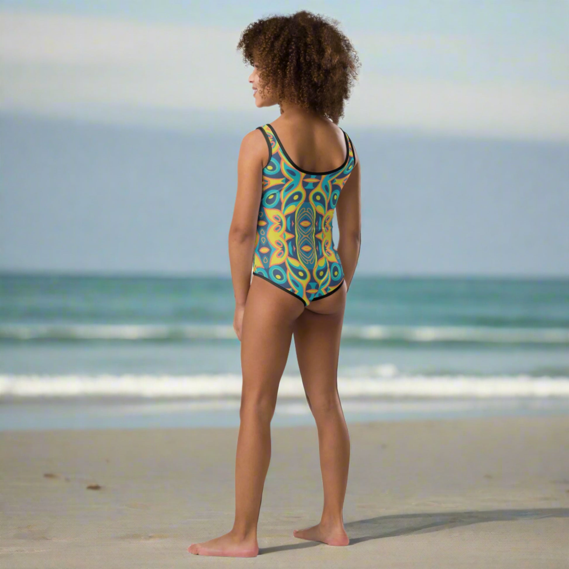 Channeling 60s style with a playful twist, this girls’ retro one-piece swimsuit (2T–7) features a colorful mid-century modern mosaic pattern that turns heads. Designed for sunny days and splashy fun, it offers sun protection, extra comfort, and stretchy fabric. A great choice for stylish summer outings, this vintage-inspired swimsuit is ideal for toddlers and little girls who love to stand out.