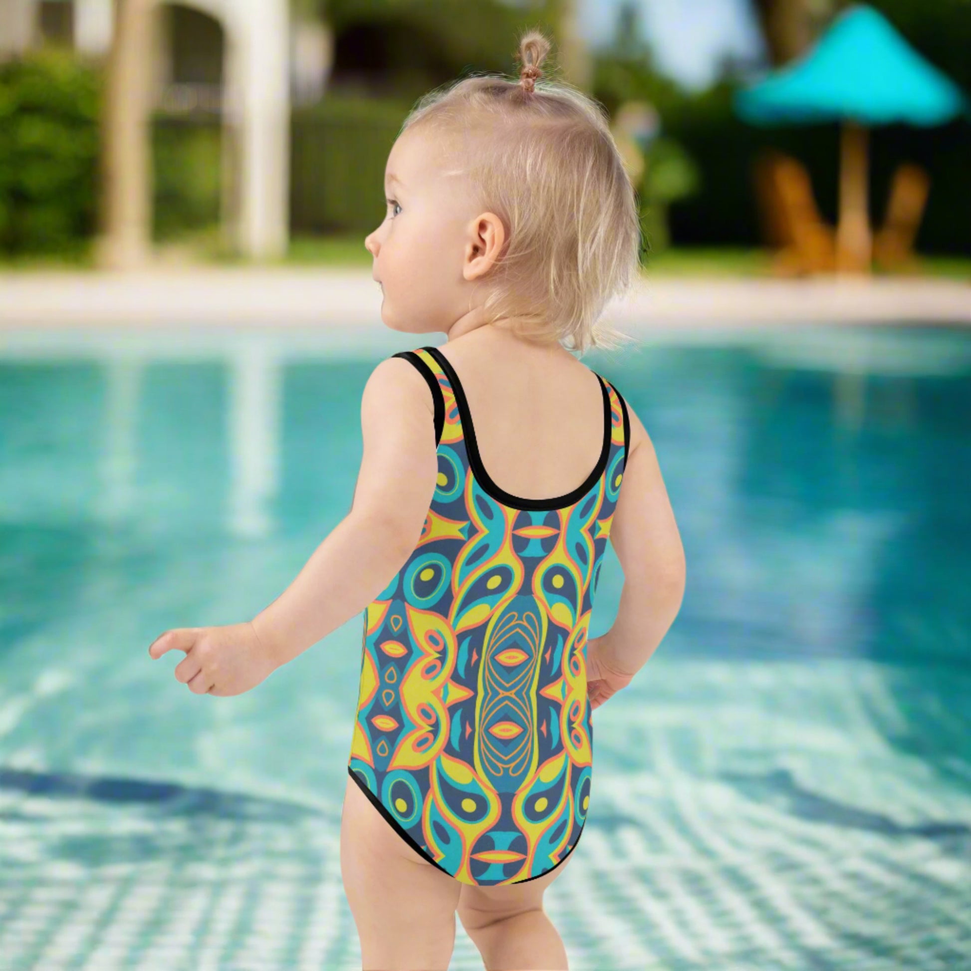 This bold and playful Mid Century Modern Mosaic Girls Swimsuit in toddler sizes 2T–7 features a retro geometric pattern inspired by 1960s style. Perfect for summer adventures, this one-piece suit offers UPF 38–40 sun protection, four-way stretch, and a soft double-layered front for extra comfort. Ideal for beach days, pool parties, or matching family vacation outfits, this vintage kids swimsuit adds personality to every splash.