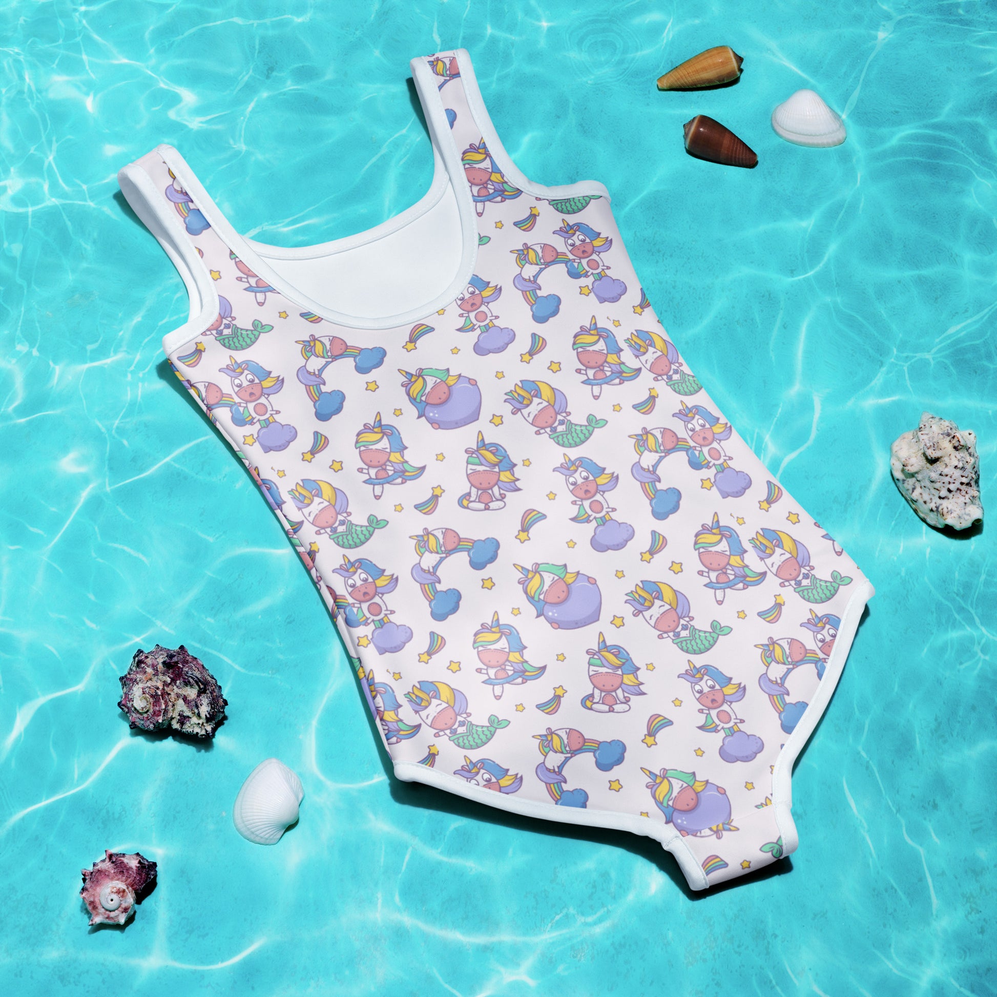 Image: Child bathing suit in toddler and girl sizes 2T-7, featuring a pink background with a cute Kawaii whimsical creature pattern of unicorn mermaids, rainbows and stars. Perfect as a Christmas gift, birthday present, or for your childs next pool party, by jaecrece