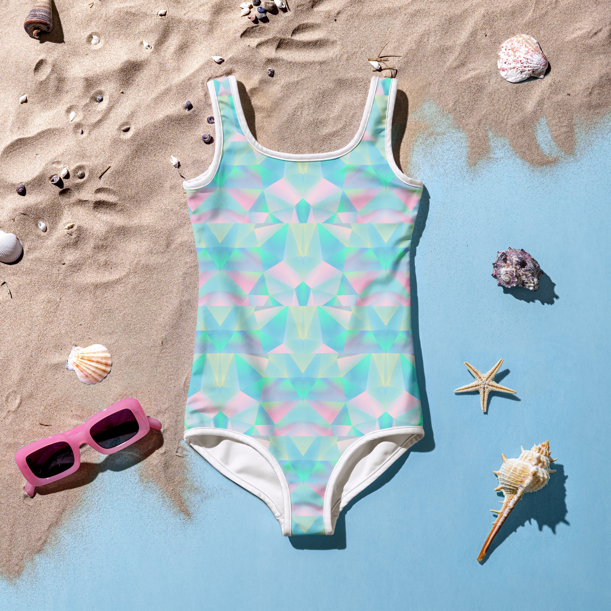 Pastel Prisms Girls Swimsuit in toddler sizes 2T–7, featuring a rainbow pastel design with UPF 38–40 sun protection, double-layered front, and soft microfiber fabric for all-day comfort. Perfect for pool parties, beach vacations, and summer play, this swimsuit is part of a family matching swimwear collection with coordinating options for older girls, women, men, and a matching beach towel.