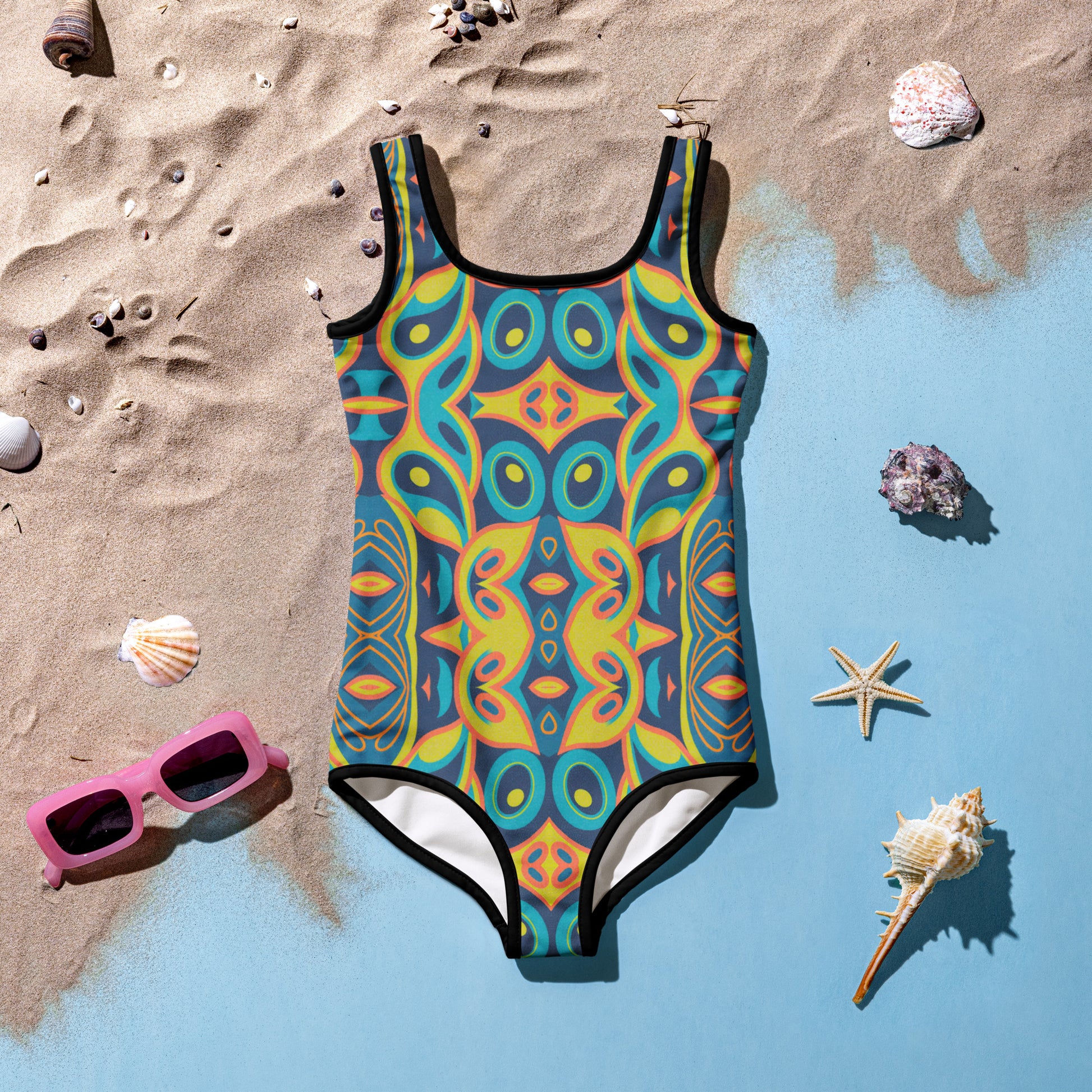 Girls mid century modern swimsuit in a vibrant blue, green, and gold mosaic pattern, finished with black trim around the edges. Sized for toddlers and young girls (2T–7), this one-piece is a standout summer swimwear piece. Designed with comfort, SPF protection, and retro charm, it’s the perfect choice for poolside fun, beach vacations, or birthday photo shoots. A stylish toddler swimsuit inspired by 1950s design.