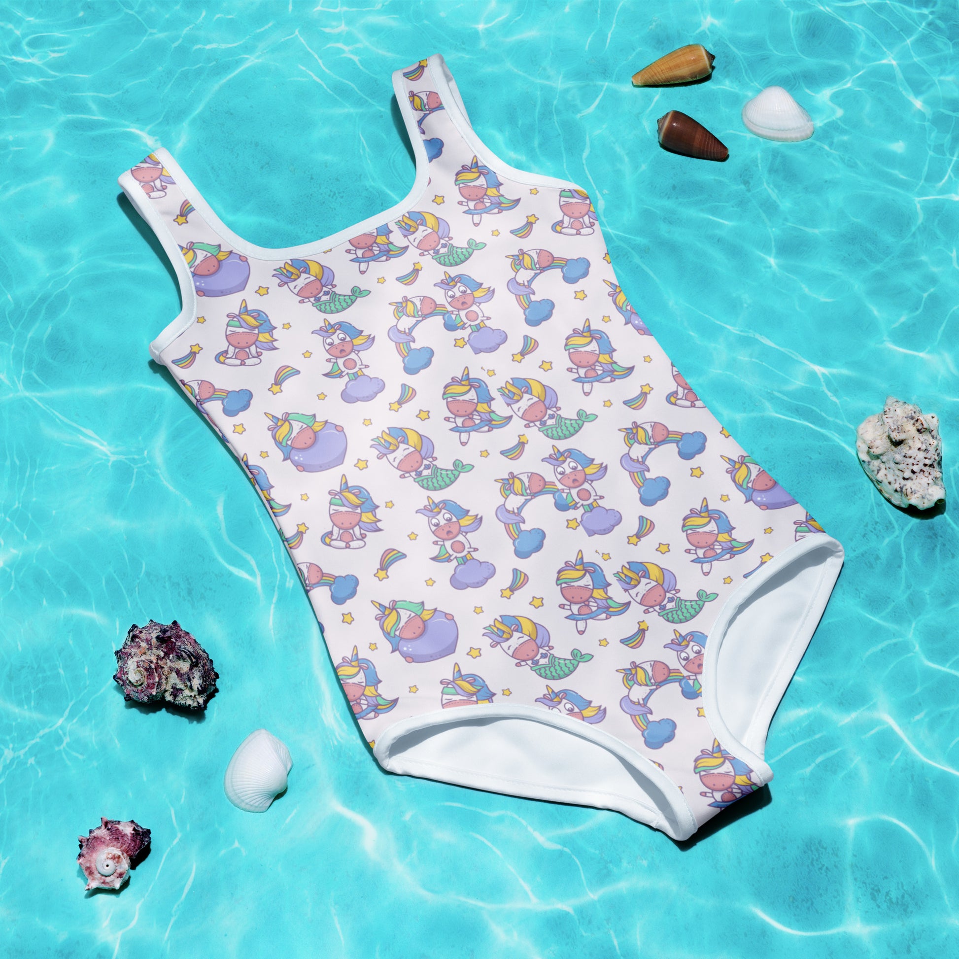 Image: Child bathing suit in toddler and girl sizes 2T-7, featuring a pink background with a cute Kawaii whimsical creature pattern of unicorn mermaids, rainbows and stars. Perfect as a Christmas gift, birthday present, or for your childs next pool party, by jaecrece
