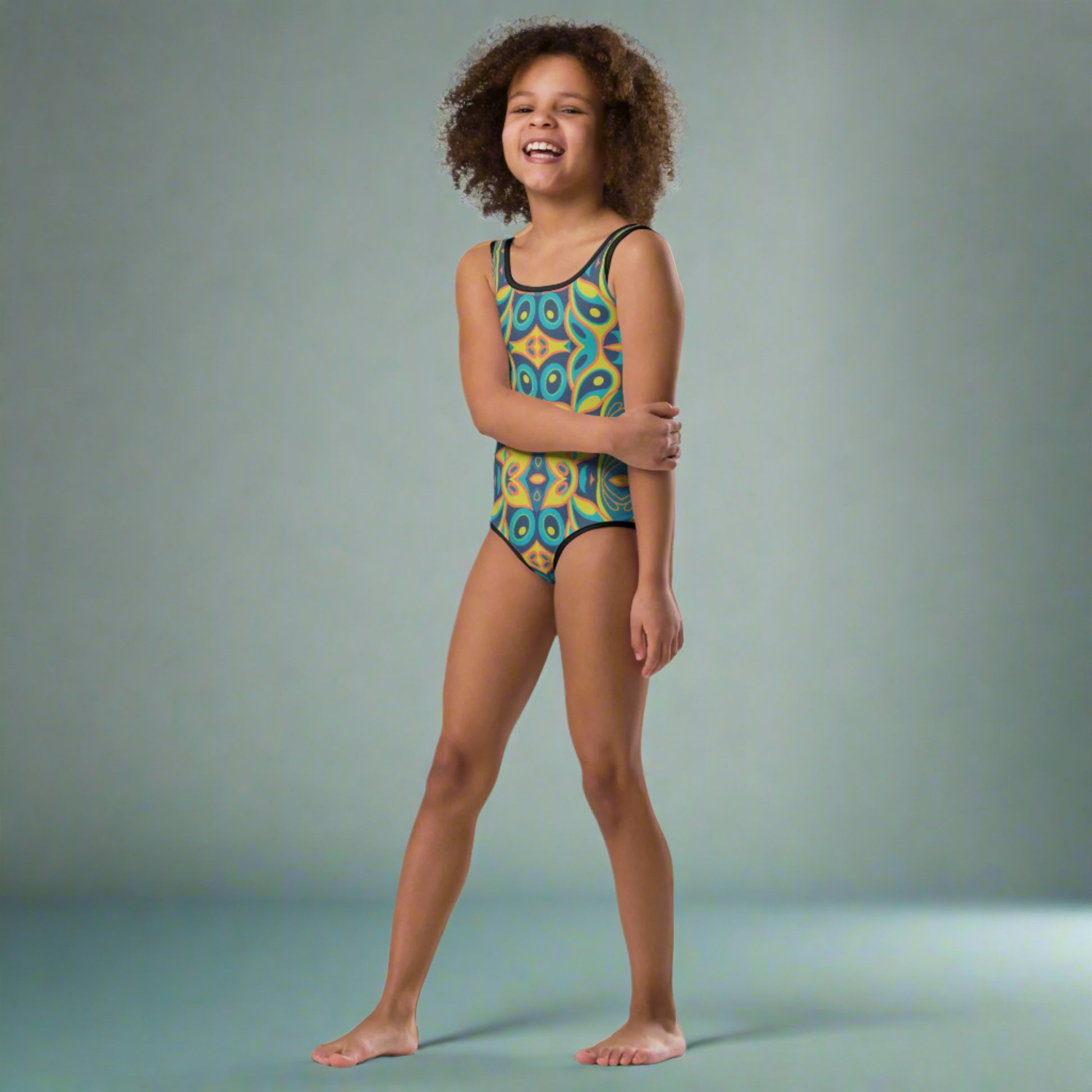 Add bold color and mid-century flair to your toddler’s summer wardrobe with this girls’ vintage mosaic swimsuit. Designed for ages 2T to 7, this soft, stretchy one-piece features built-in sun protection and a standout retro design perfect for pool parties, sprinklers, and seaside vacations. A trendy pick for families who love mod patterns and retro fashion with comfort and functionality.