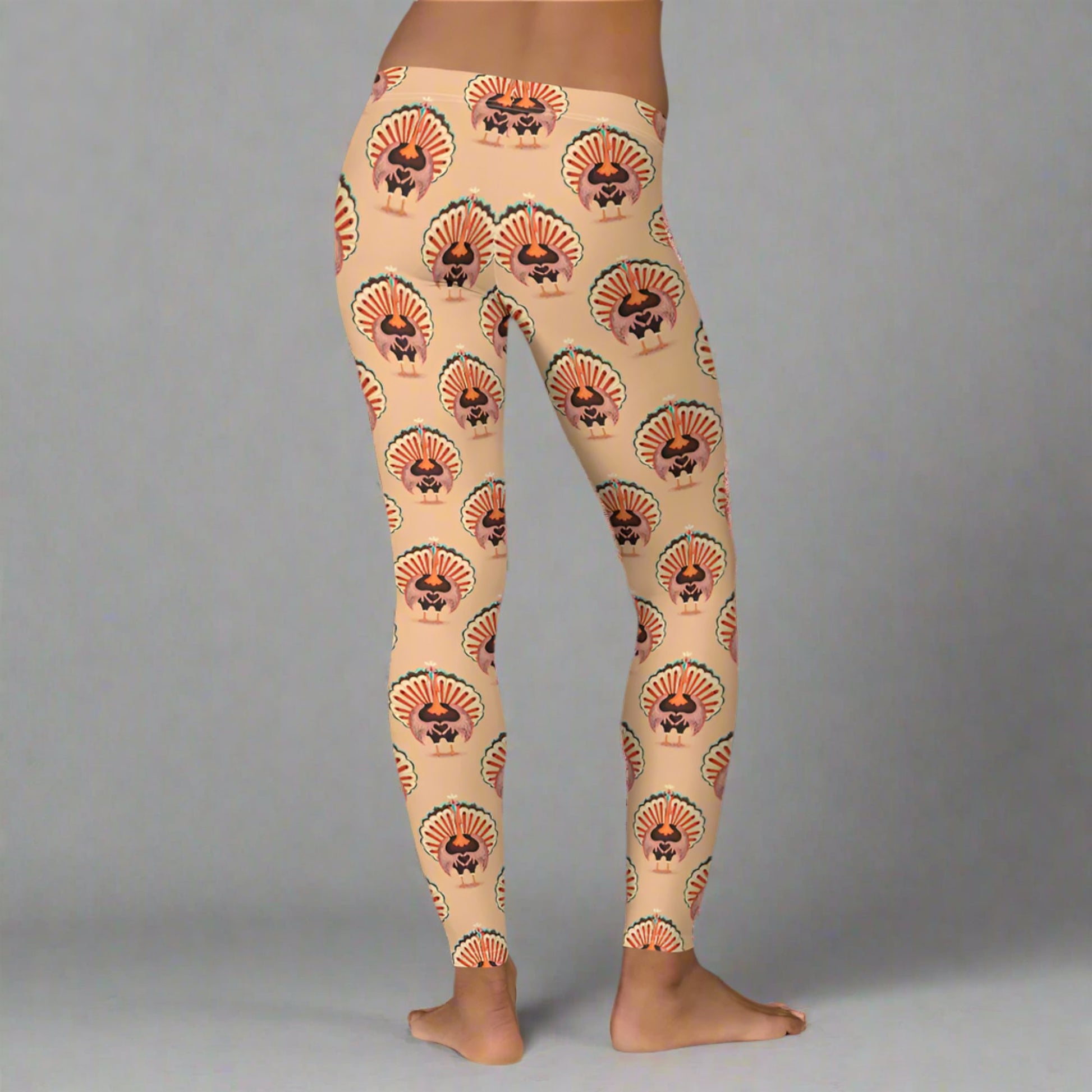 Thanksgiving Turkey Love ladies leggings. These womens yoga pants are peach, and have a repeating pattern of turkeys showing the love sign with their hands. These womens tights make a great gift, or a family matching outfit for the Turkey Trot! by jaecrece
