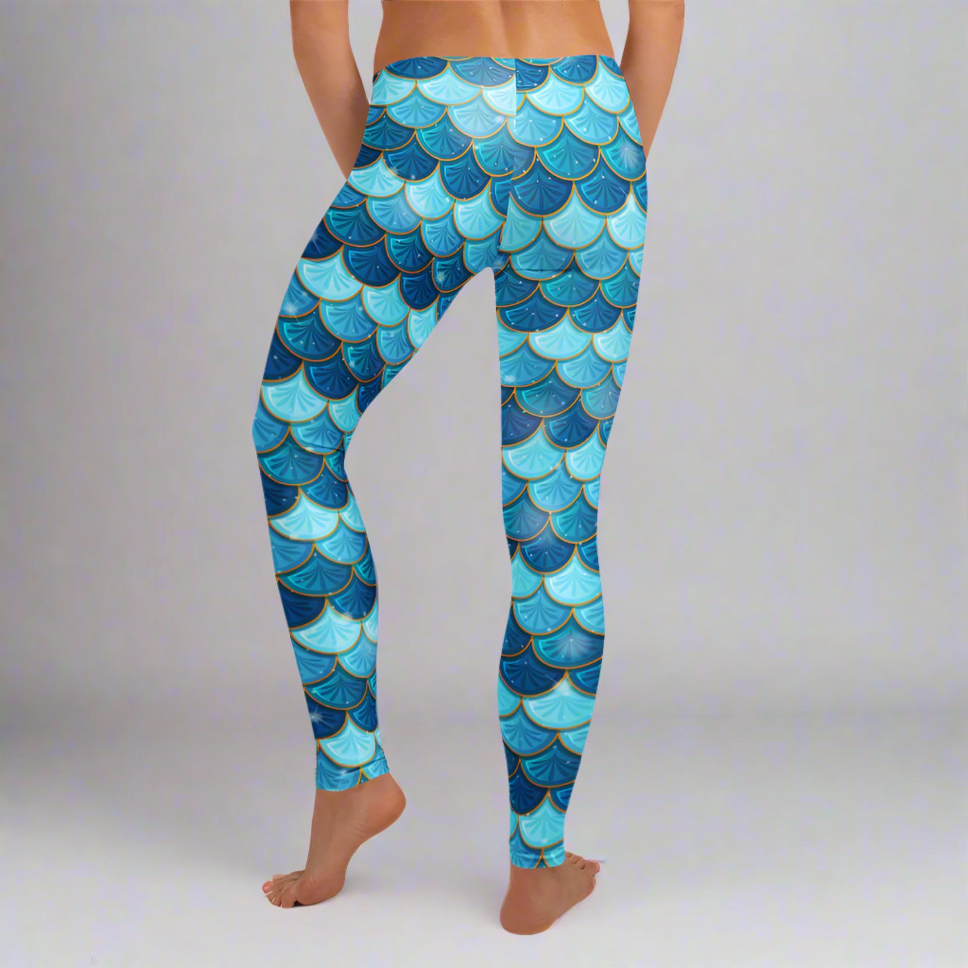 Image: Blue Mermaid Scales Leggings for Women. These mermaidcore aesthetic yoga pants have mermaid scales in shades of blue and teal with gold accents. Perfect for birthday parties, bachelorette parties, or Halloween mermaid costumes, by jaecrece