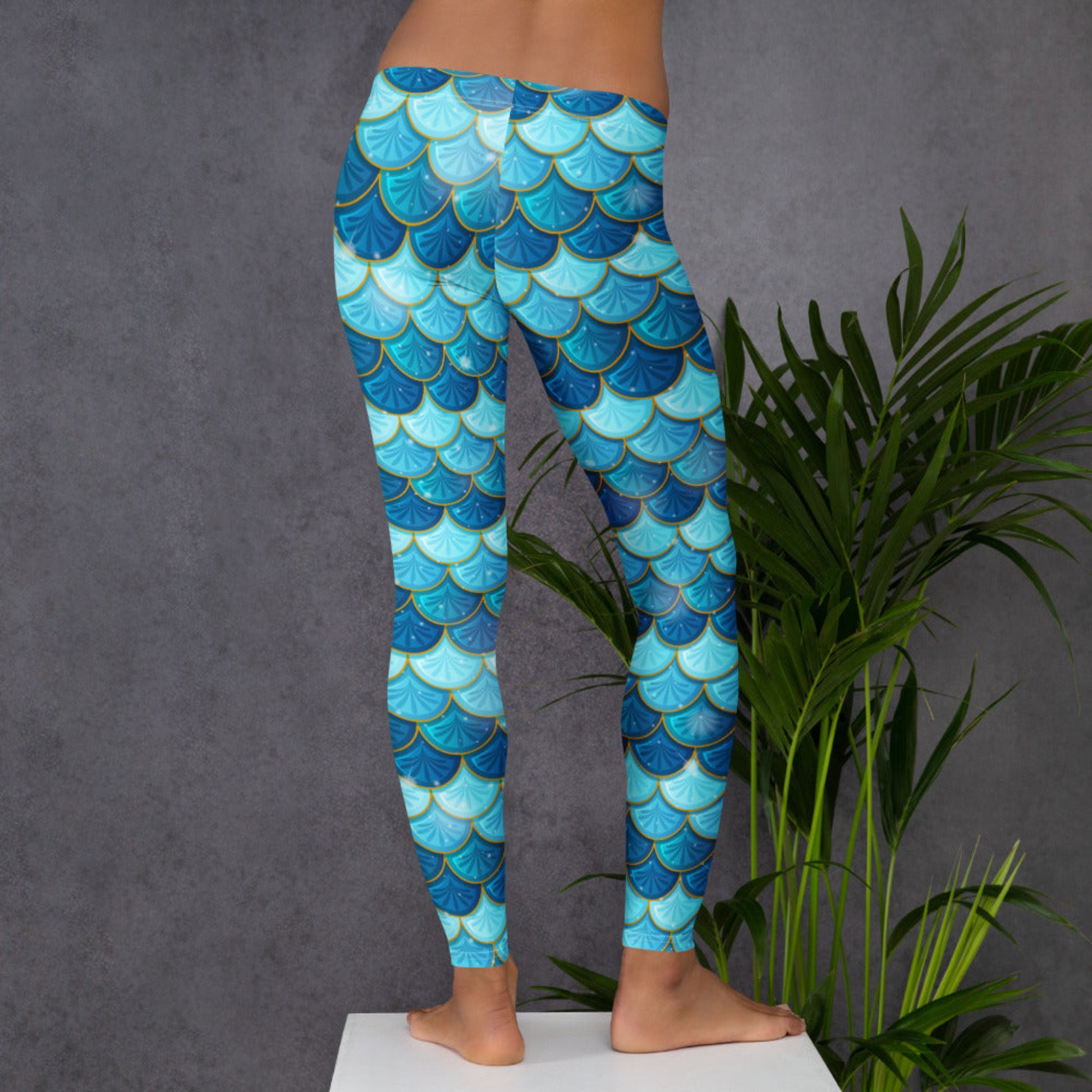 Image: Blue Mermaid Scales Leggings for Women. These mermaidcore aesthetic yoga pants have mermaid scales in shades of blue and teal with gold accents. Perfect for birthday parties, bachelorette parties, or Halloween mermaid costumes, by jaecrece
