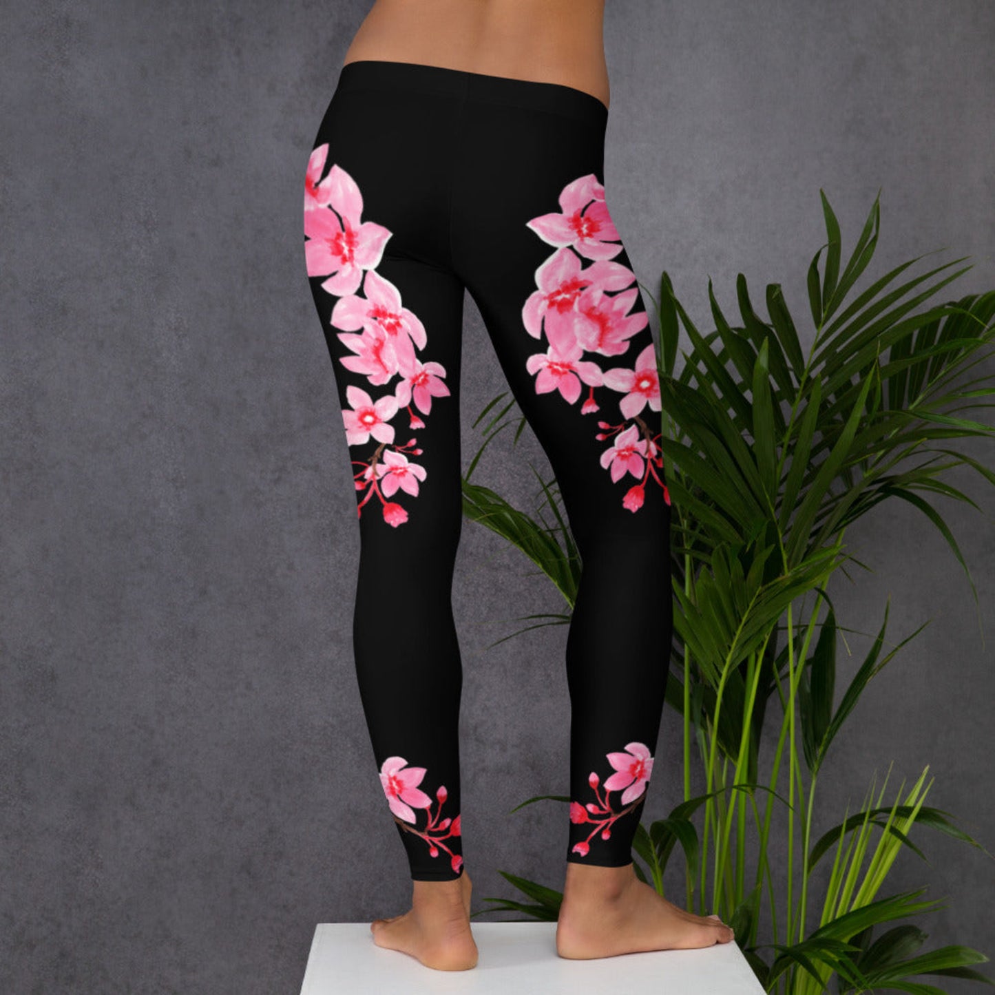 Image: Japanese Cherry Blossom Leggings. These black yoga pants have bright pink swirling down the legs. The perfect sakura gift for the Japanese cherry blossom lover in your life, by jaecrece