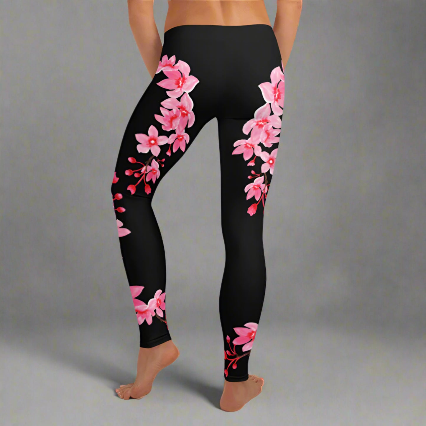 Image: Japanese Cherry Blossom Leggings. These black yoga pants have bright pink swirling down the legs. The perfect sakura gift for the Japanese cherry blossom lover in your life, by jaecrece