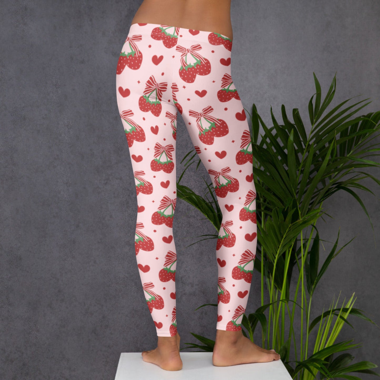 Image: With a light pink base and scattered red bows and strawberries, these women’s leggings bring soft girl and coquette aesthetics to life. Designed in sizes XS to XL, they flatter and stretch with ease, making them perfect for yoga, brunch, or lounging in style. Sweet and whimsical, they’re ideal for women who love fun patterns and feminine flair in their everyday wardrobe, by jaecrece.