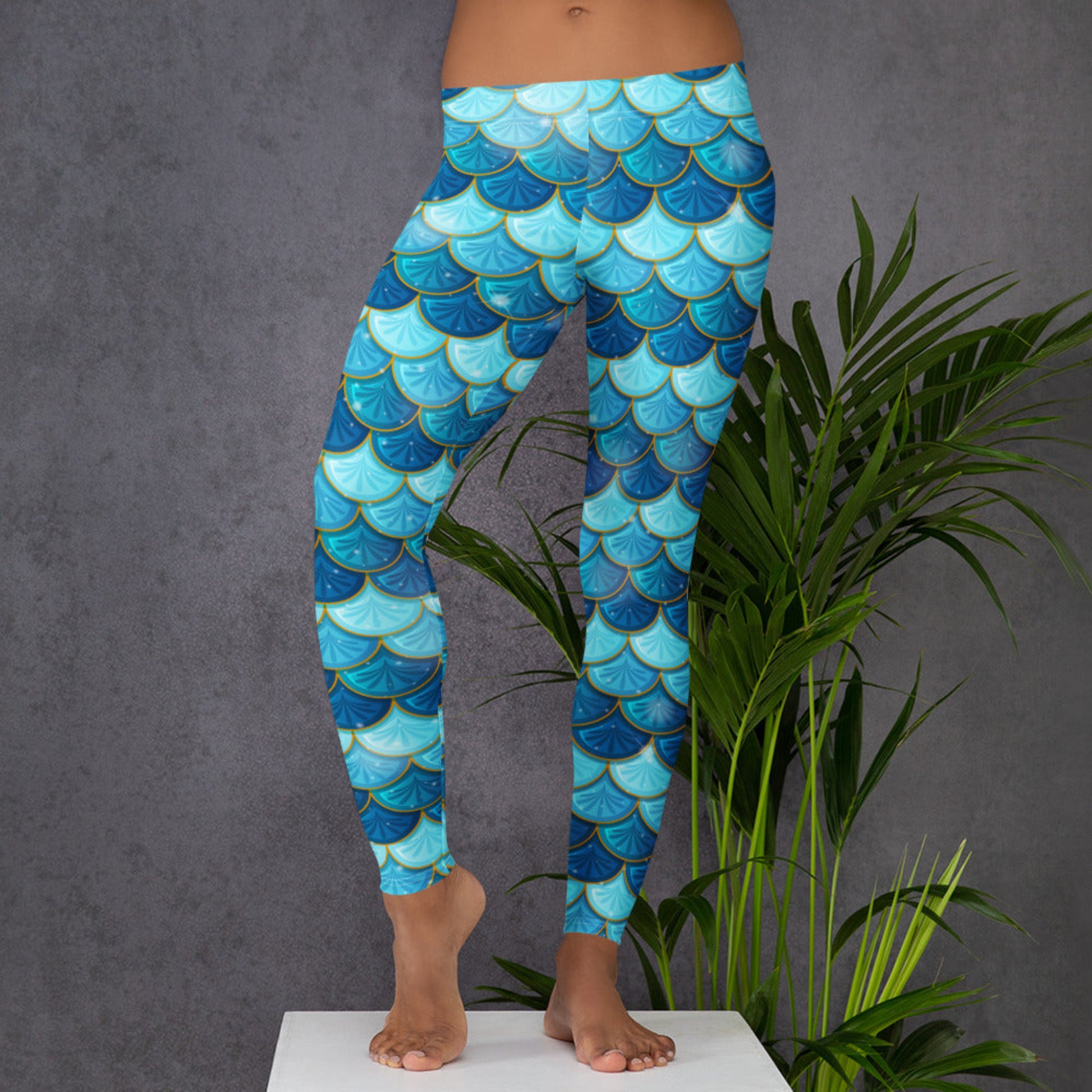 Image: Blue Mermaid Scales Leggings for Women. These mermaidcore aesthetic yoga pants have mermaid scales in shades of blue and teal with gold accents. Perfect for birthday parties, bachelorette parties, or Halloween mermaid costumes, by jaecrece