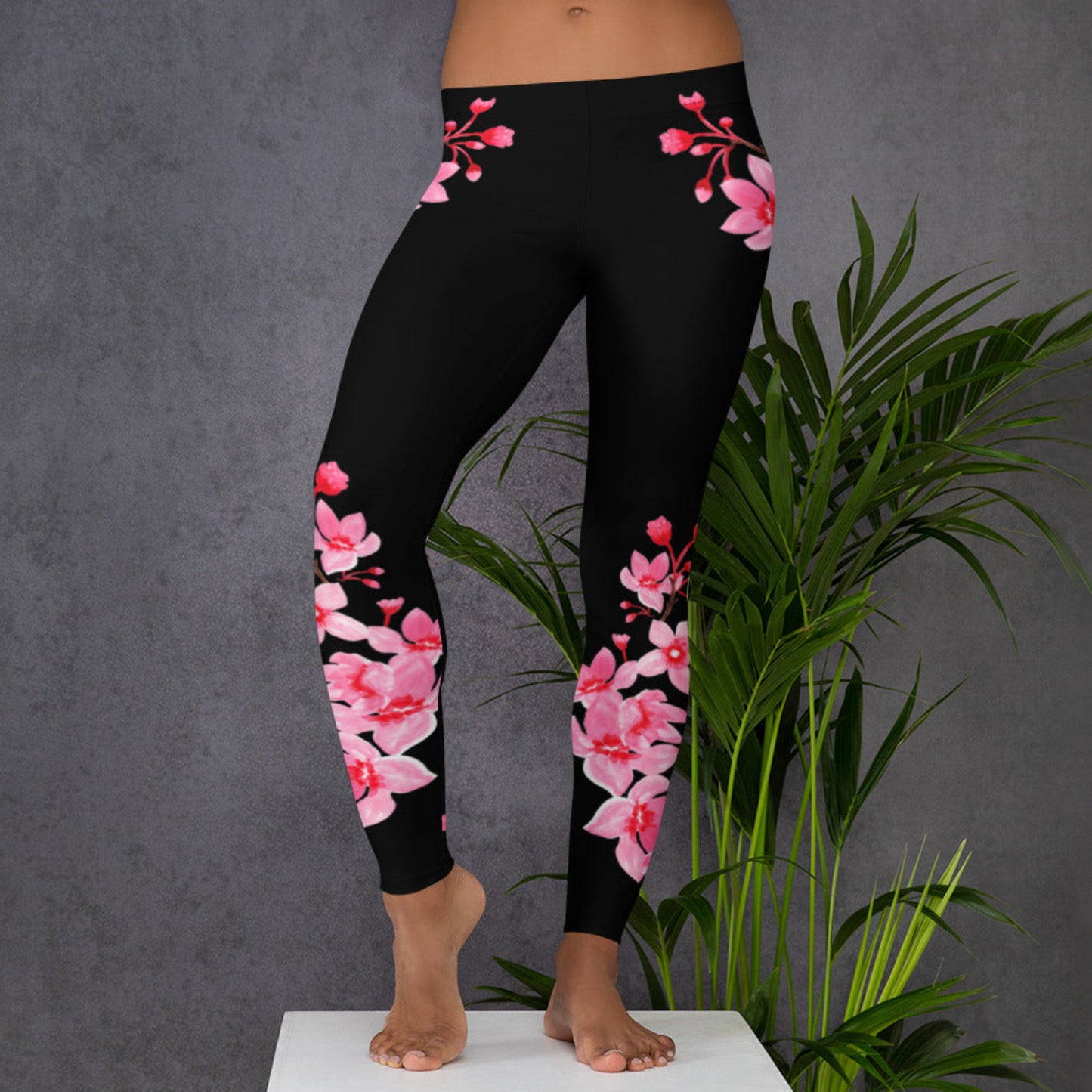 Image: Japanese Cherry Blossom Leggings. These black yoga pants have bright pink swirling down the legs. The perfect sakura gift for the Japanese cherry blossom lover in your life, by jaecrece