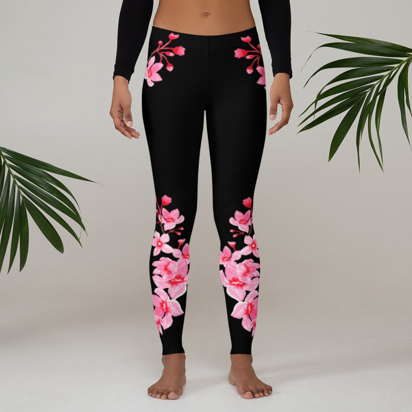Image: Japanese Cherry Blossom Leggings. These black yoga pants have bright pink swirling down the legs. The perfect sakura gift for the Japanese cherry blossom lover in your life, by jaecrece