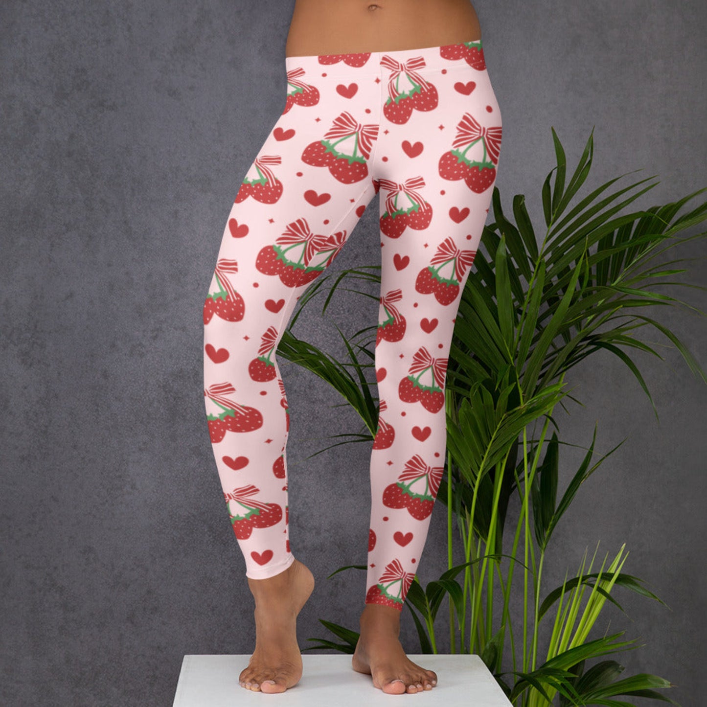 Image: Add a dash of flirty fun to your wardrobe with these pink coquette leggings, adorned with juicy strawberries and striped bows. Available in women’s sizes XS to XL, they deliver comfort with personality. Great for casual styling, dance classes, or matching mommy and me outfits, these leggings bring playful energy to every occasion and make a charming gift idea, by jaecrece.
