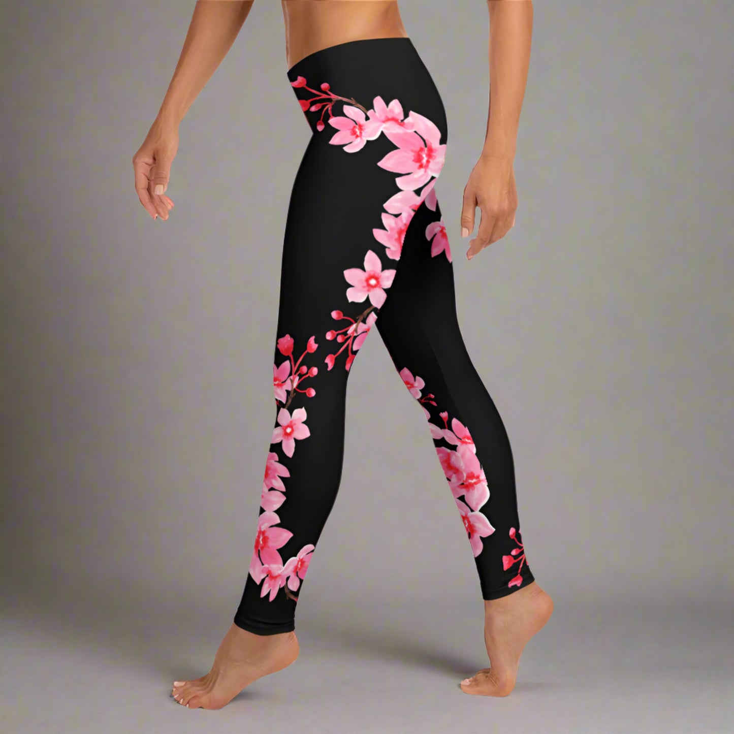Image: Japanese Cherry Blossom Leggings. These black yoga pants have bright pink swirling down the legs. The perfect sakura gift for the Japanese cherry blossom lover in your life, by jaecrece