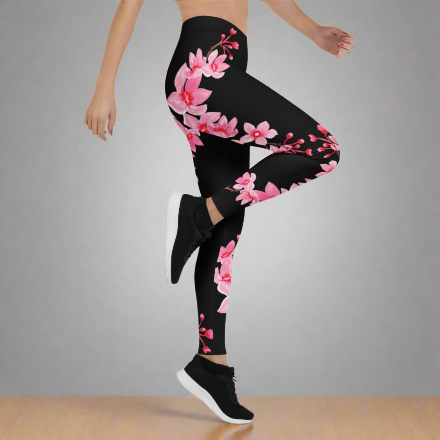 Image: Japanese Cherry Blossom Leggings. These black yoga pants have bright pink swirling down the legs. The perfect sakura gift for the Japanese cherry blossom lover in your life, by jaecrece