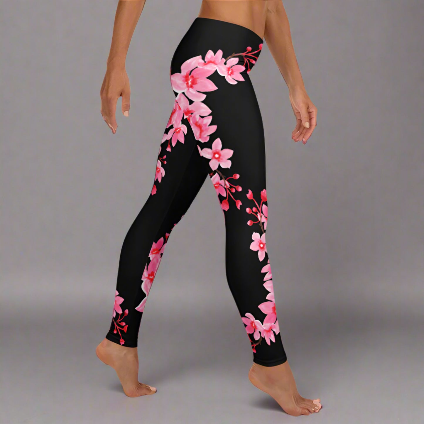 Image: Japanese Cherry Blossom Leggings. These black yoga pants have bright pink swirling down the legs. The perfect sakura gift for the Japanese cherry blossom lover in your life, by jaecrece