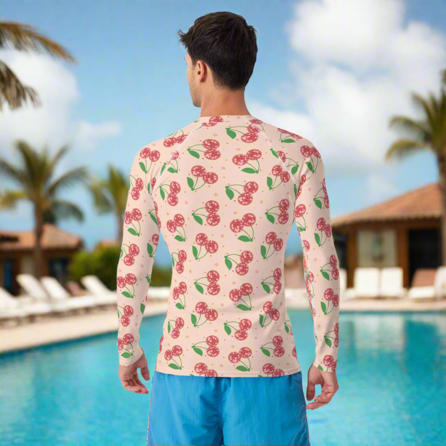 Image: Disco Cherries Mens Rash Guard, part of a family matching swimwear collection. This rash guard has a pink background, with a pattern of red disco ball cherries and stars, by jaecrece