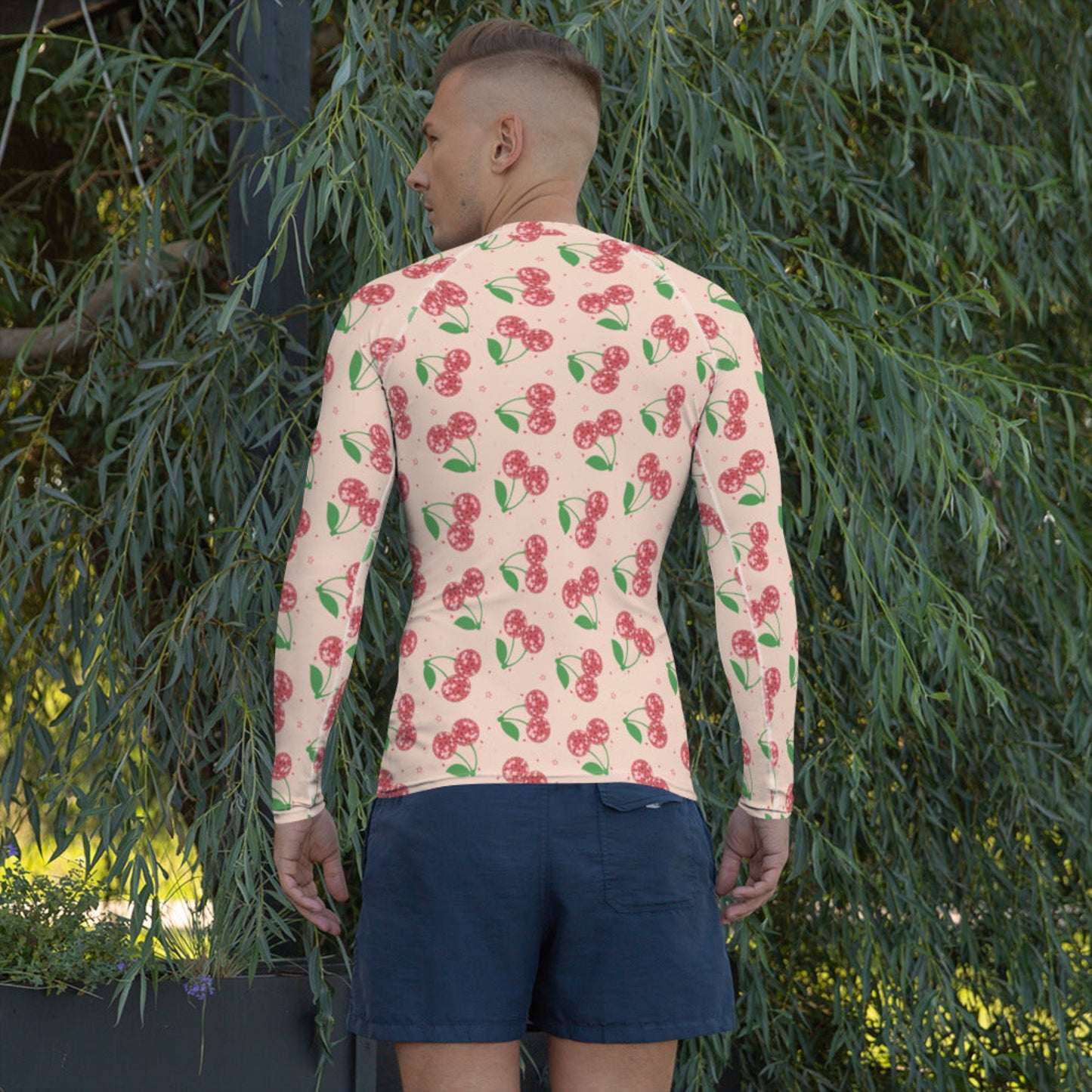 Image: Disco Cherries Mens Rash Guard, part of a family matching swimwear collection. This rash guard has a pink background, with a pattern of red disco ball cherries and stars, by jaecrece