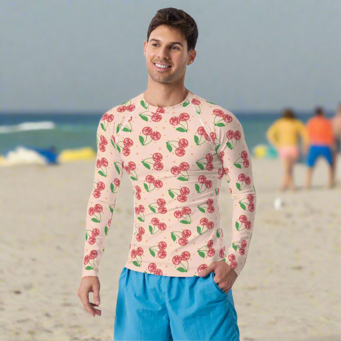 Image: Disco Cherries Mens Rash Guard, part of a family matching swimwear collection. This rash guard has a pink background, with a pattern of red disco ball cherries and stars, by jaecrece