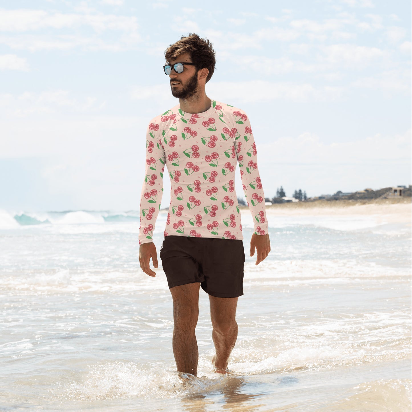 Image: Disco Cherries Mens Rash Guard, part of a family matching swimwear collection. This rash guard has a pink background, with a pattern of red disco ball cherries and stars, by jaecrece
