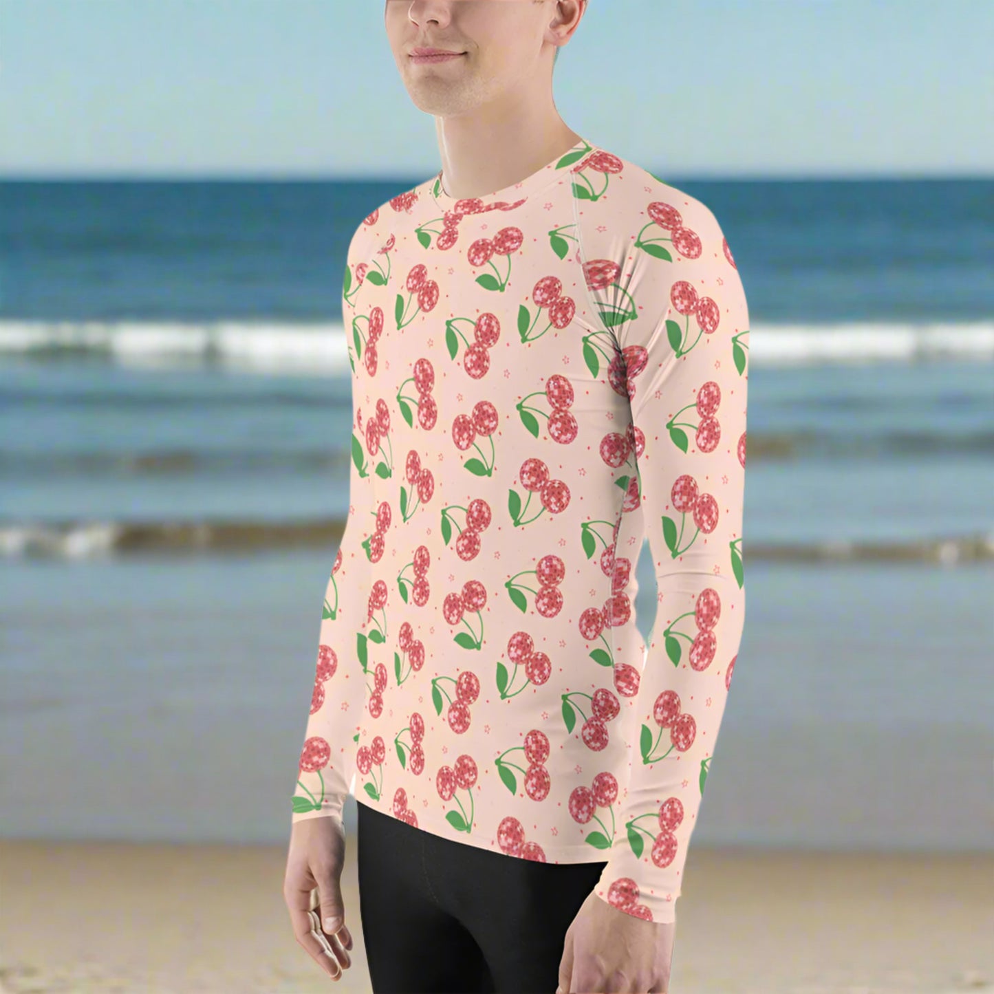 Image: Disco Cherries Mens Rash Guard, part of a family matching swimwear collection. This rash guard has a pink background, with a pattern of red disco ball cherries and stars, by jaecrece