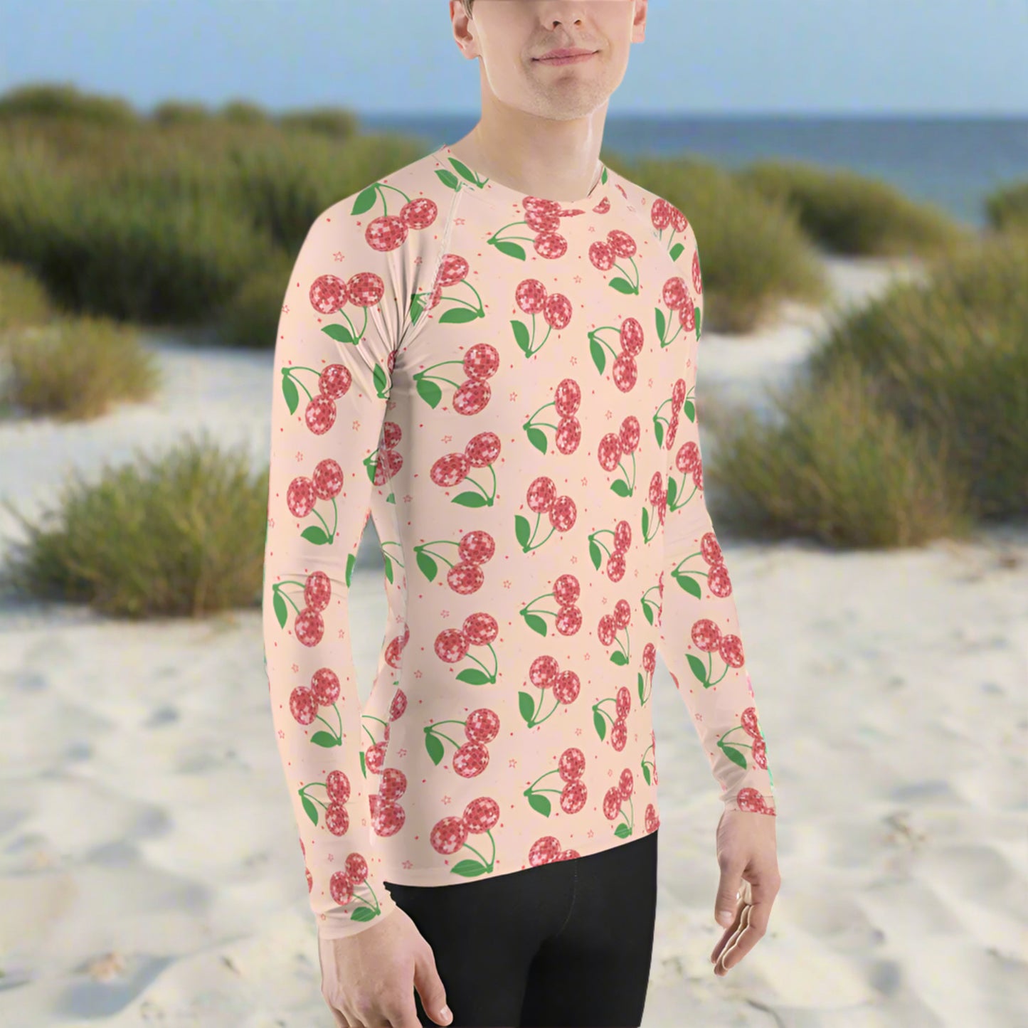 Image: Disco Cherries Mens Rash Guard, part of a family matching swimwear collection. This rash guard has a pink background, with a pattern of red disco ball cherries and stars, by jaecrece