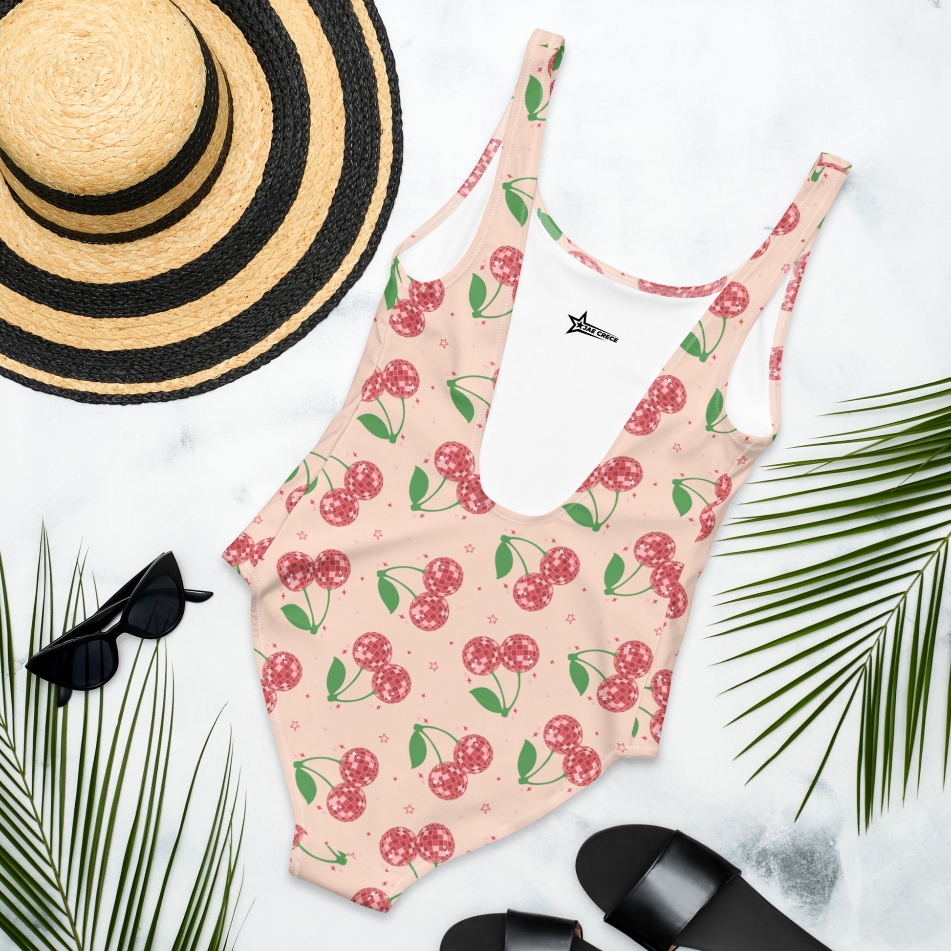 Image: Disco Cherries Women's One Piece Swimsuit, This fruit inspired swimsuit is a part of our Family Matching Swimwear Collection, and features a pink background with red disco ball cherries and stars, by jaecrece