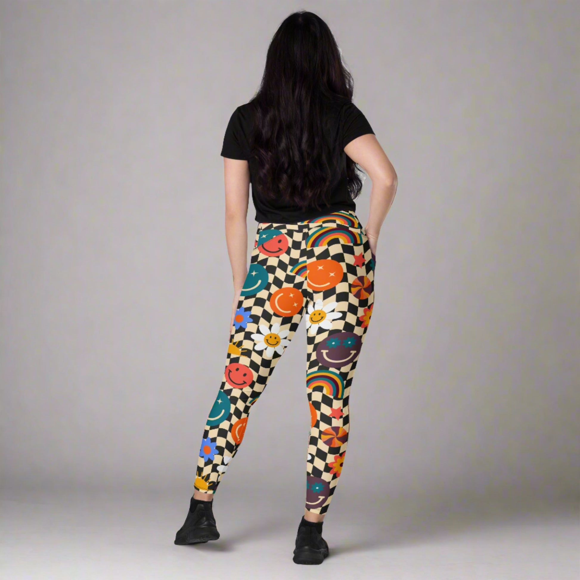 Smiley Face Checkerboard Adult Leggings. These cute retro leggings feature a black and khaki checkerboard background, with smiley face, rainbow and daisy graphics. In adult ladies sizes. by jaecrece.com - jaecrece