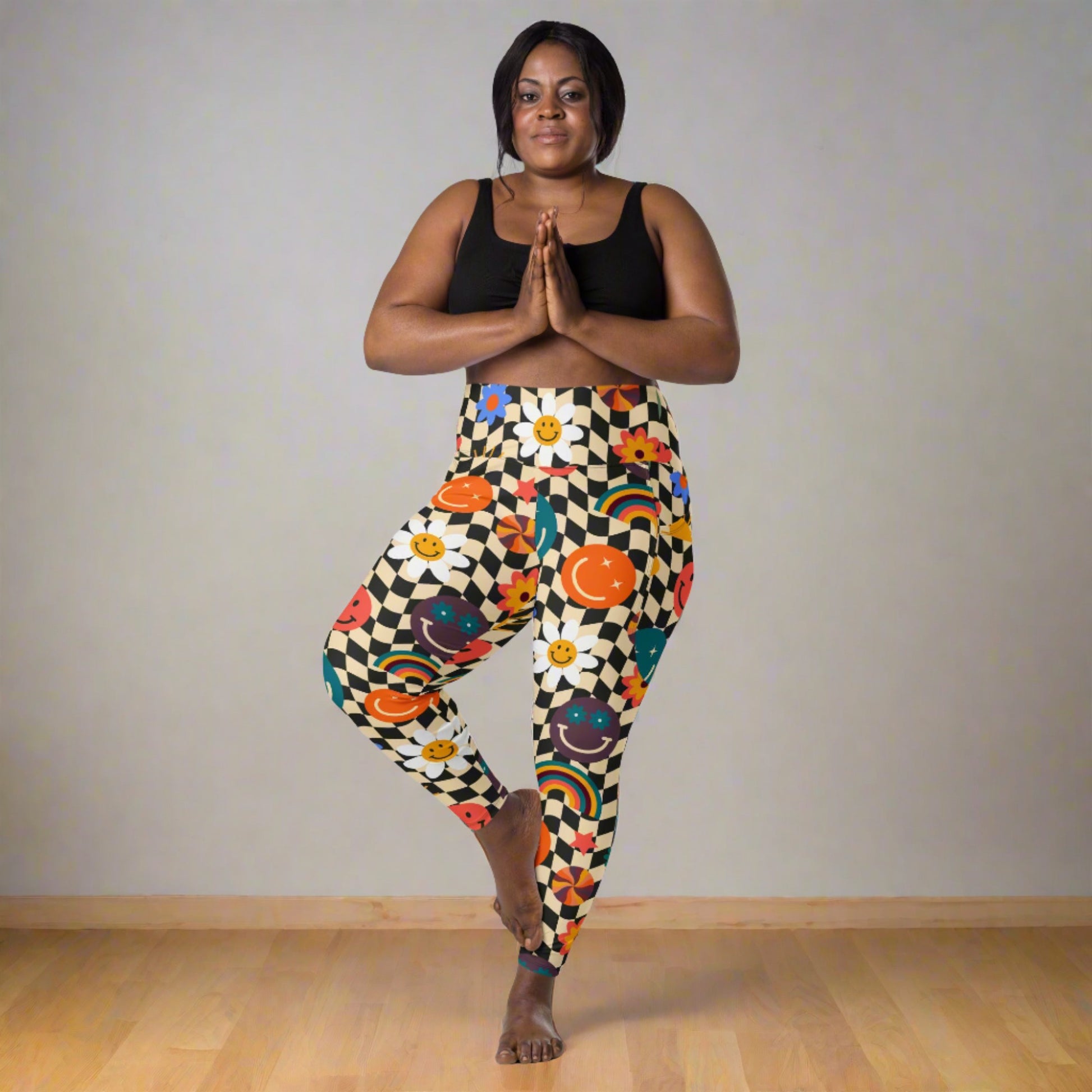 Smiley Face Checkerboard Adult Leggings. These cute retro leggings feature a black and khaki checkerboard background, with smiley face, rainbow and daisy graphics. In adult ladies sizes. by jaecrece.com - jaecrece