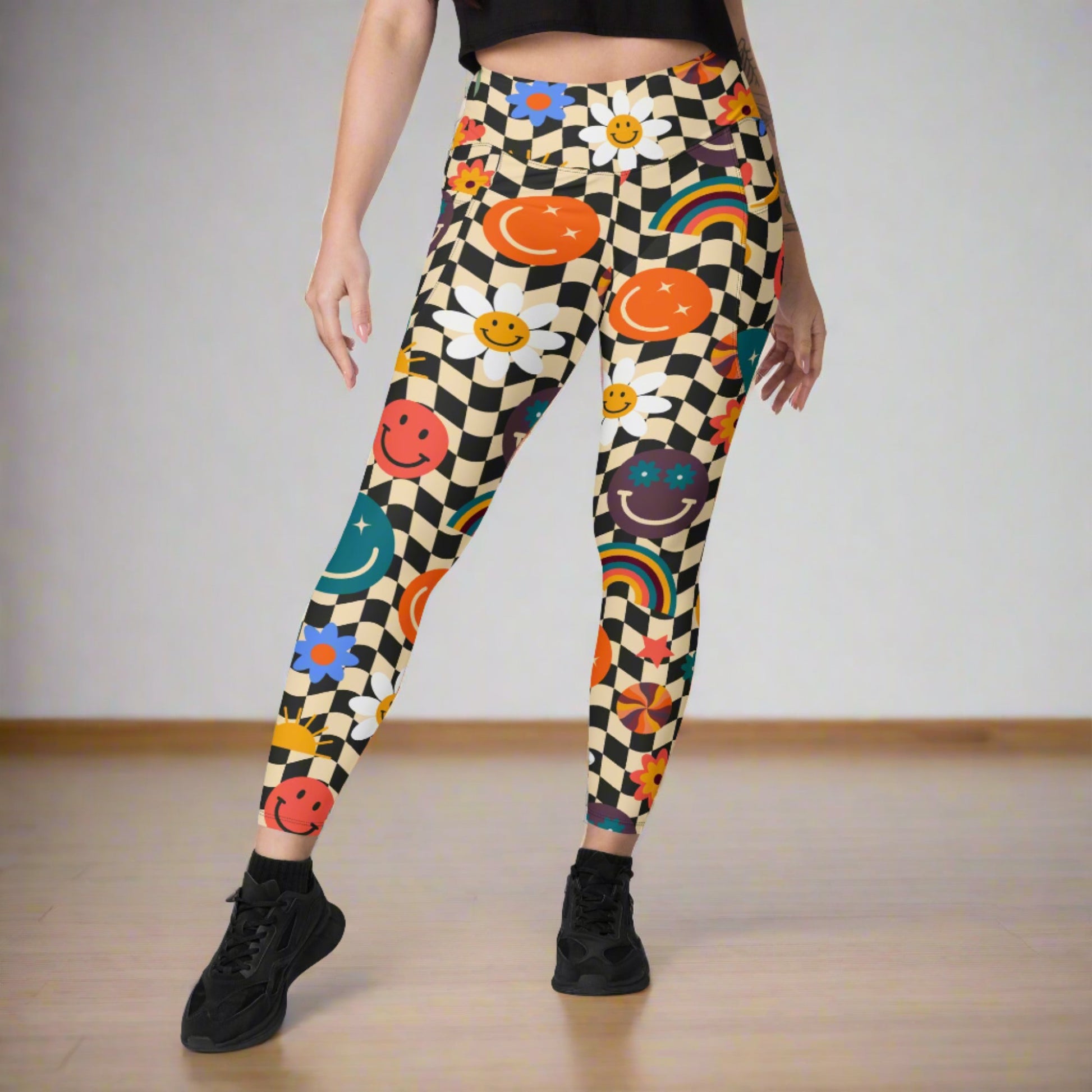 Smiley Face Checkerboard Adult Leggings. These cute retro leggings feature a black and khaki checkerboard background, with smiley face, rainbow and daisy graphics. In adult ladies sizes. by jaecrece.com - jaecrece