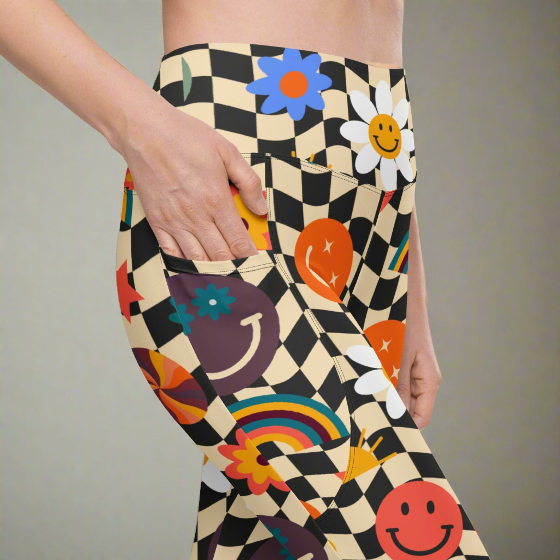 Smiley Face Checkerboard Adult Leggings. These cute retro leggings feature a black and khaki checkerboard background, with smiley face, rainbow and daisy graphics. In adult ladies sizes. by jaecrece.com - jaecrece