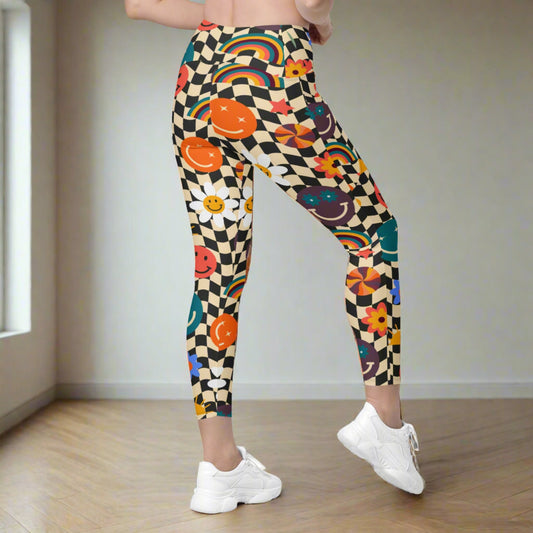 Smiley Face Checkerboard Adult Leggings. These cute retro leggings feature a black and khaki checkerboard background, with smiley face, rainbow and daisy graphics. In adult ladies sizes. by jaecrece.com - jaecrece