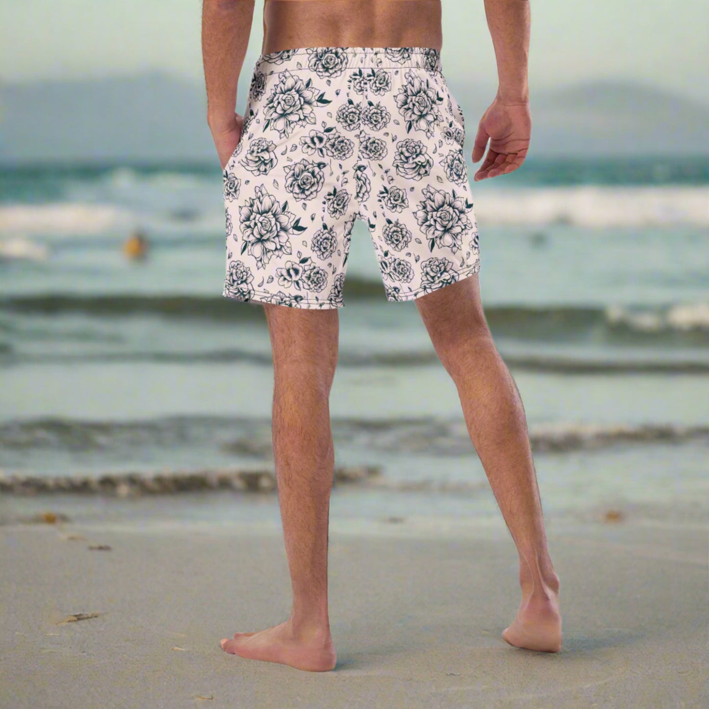Eco-conscious and eye-catching, these Pink Tattoo Roses Men’s Swim Trunks are crafted with 91% recycled polyester and feature a bold black rose print on hot pink. UPF 50+ protection, anti-chafe mesh liner, and practical pockets make them functional for beach days or poolside hangs. A great match for dad-and-kid swim sets or anyone looking to make a stylish and sustainable statement during summer adventures or tropical getaways.